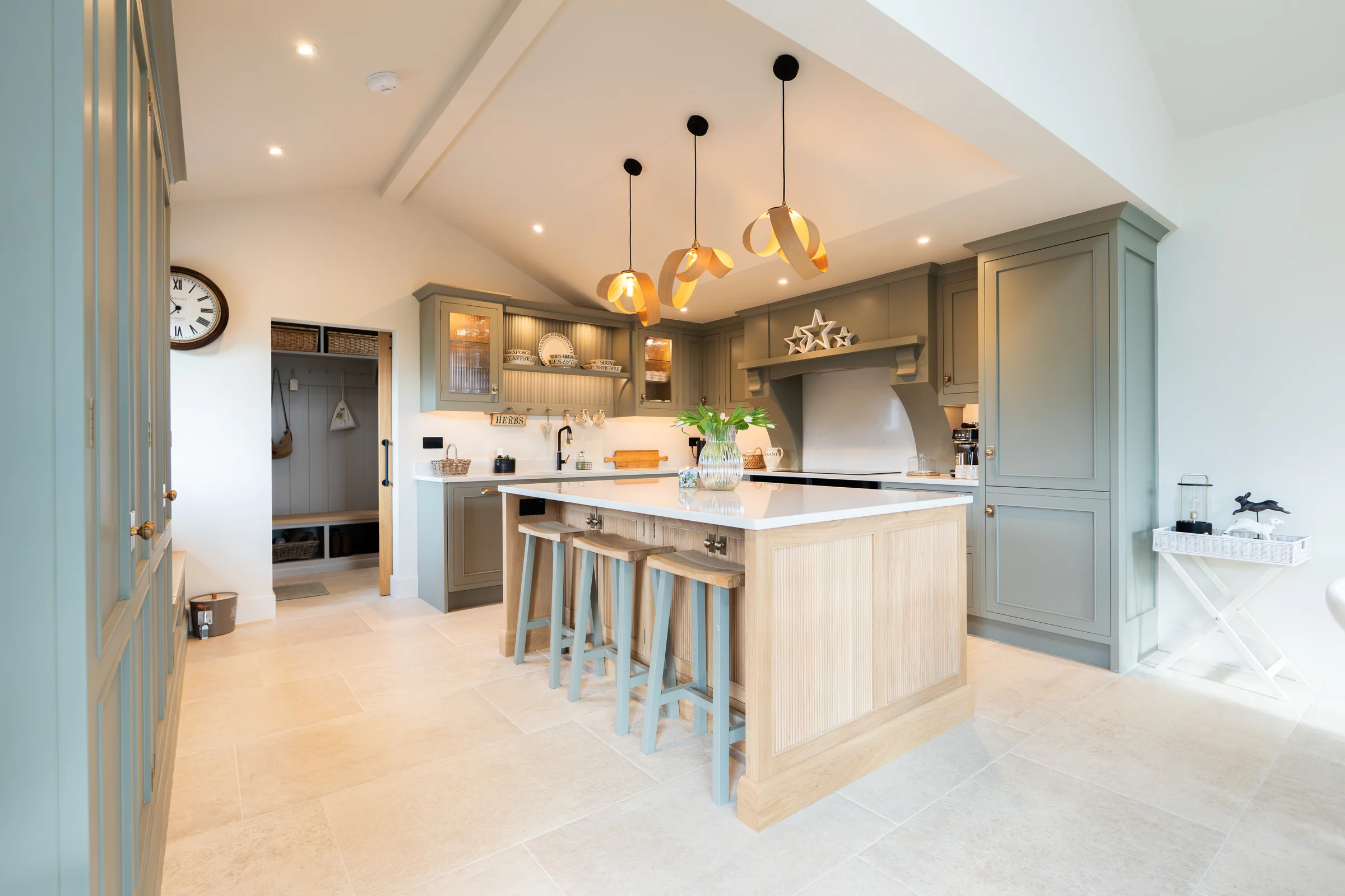Full kitchen vaulted ceiling alt ribbon pendants oak island grey units boot room