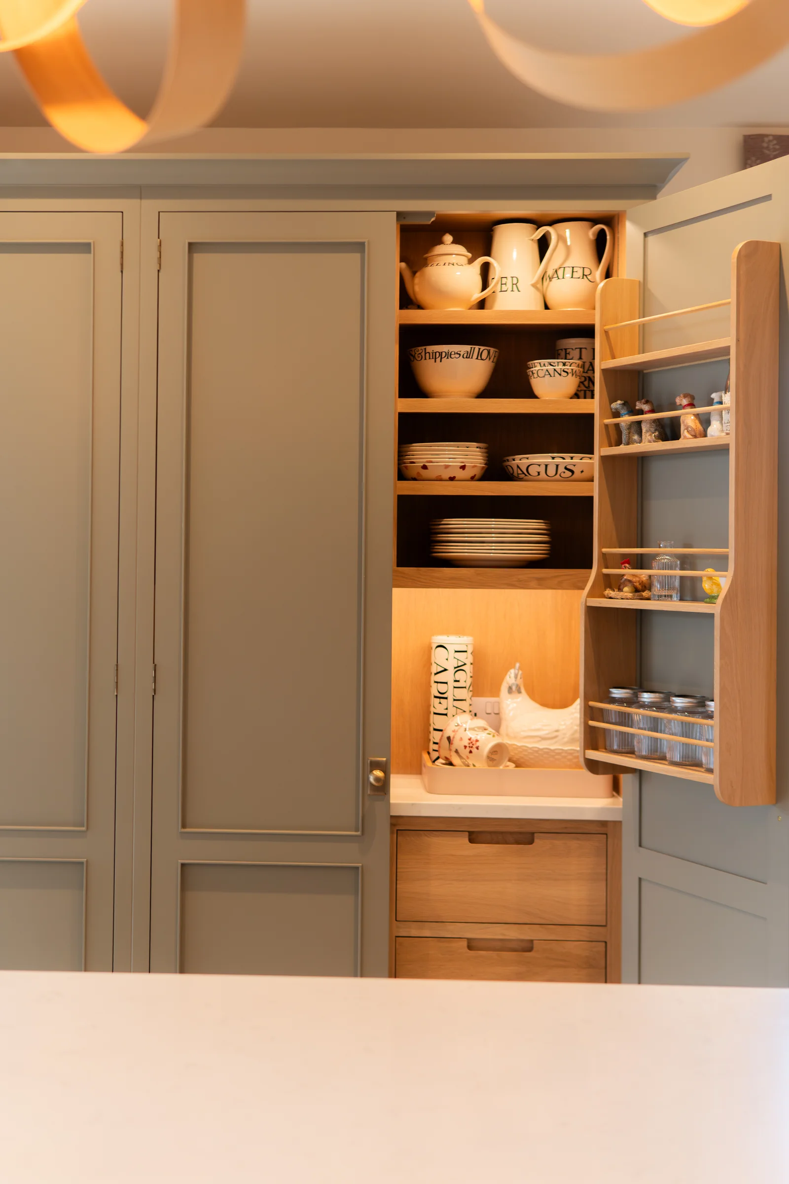 Grey pantry partially closed spice rack door crockery visible