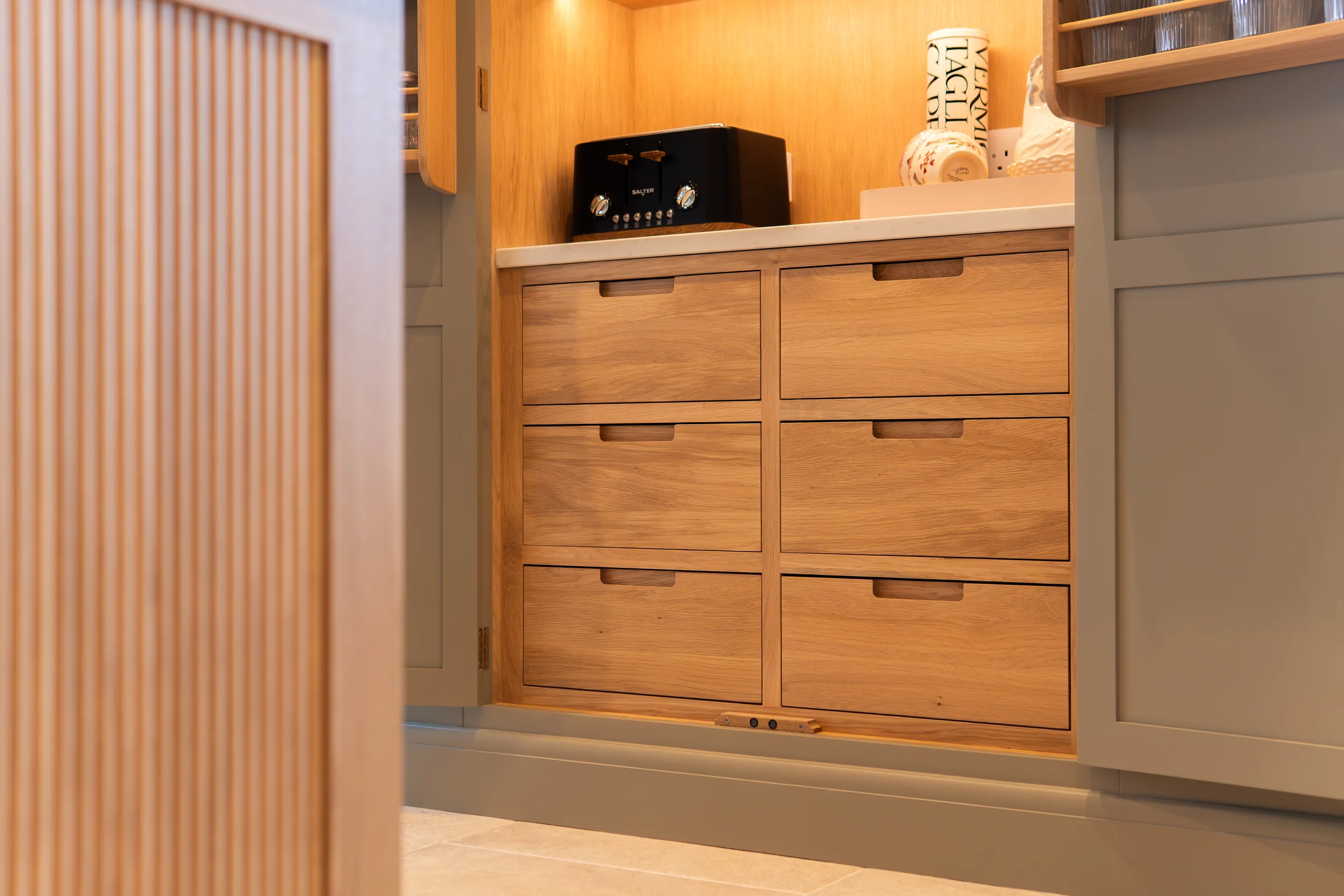 Pantry oak internal drawers closeup black handles toaster oak slat panel