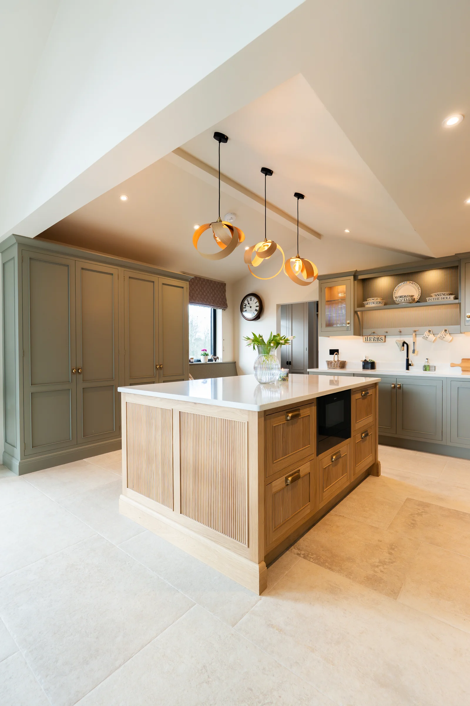Portrait opposite angle oak island oven niche grey tall units ribbon pendants vaulted