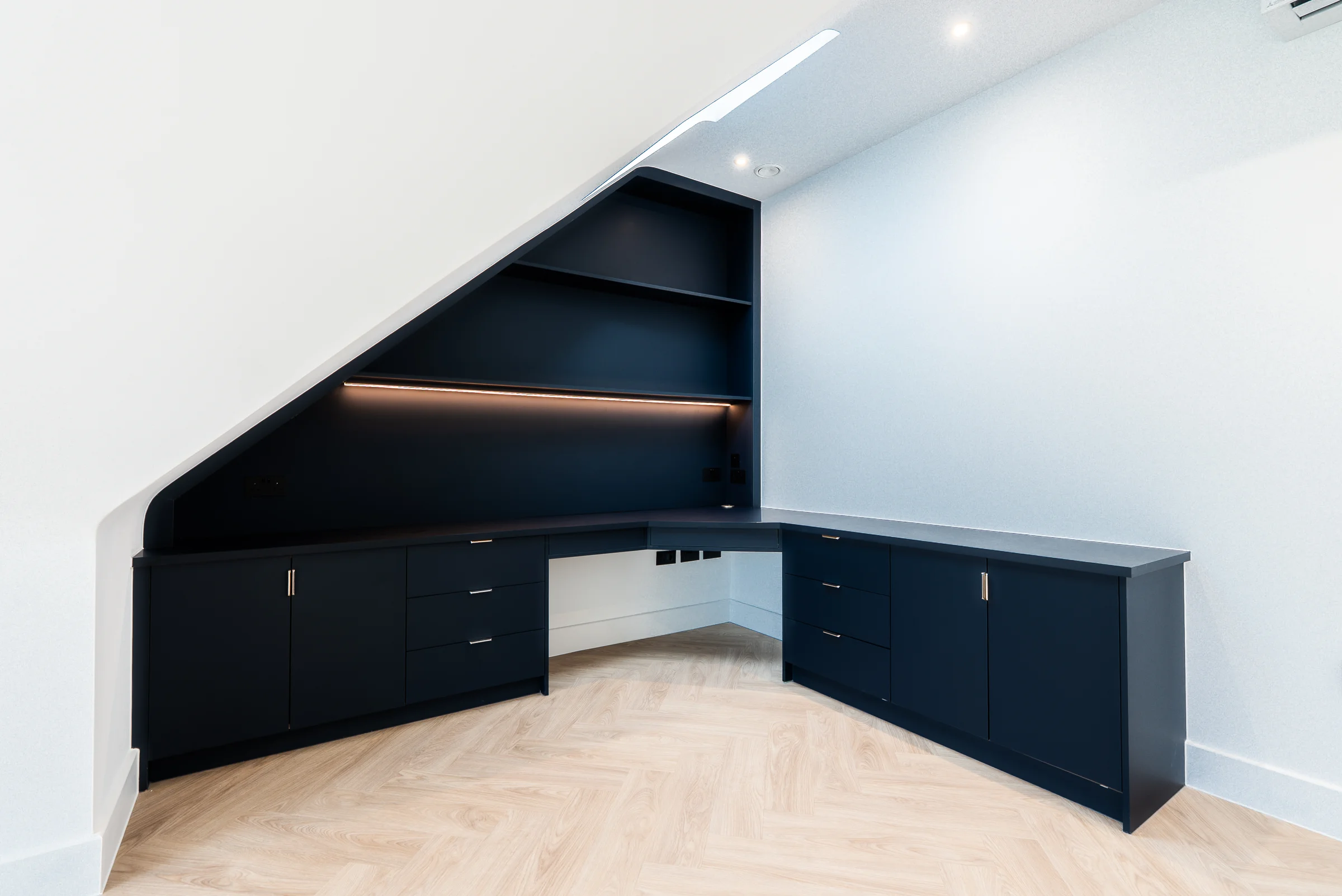 Dark navy corner desk led shelf strip eaves skylight herringbone floor