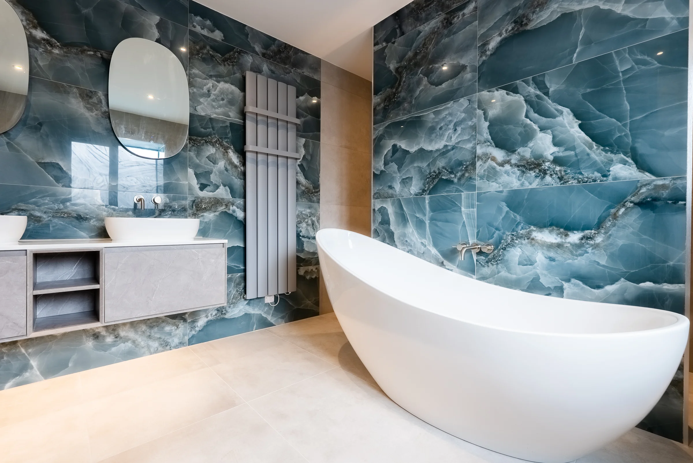 Ensuite freestanding bath blue onyx walls floating vanity oval mirror radiator