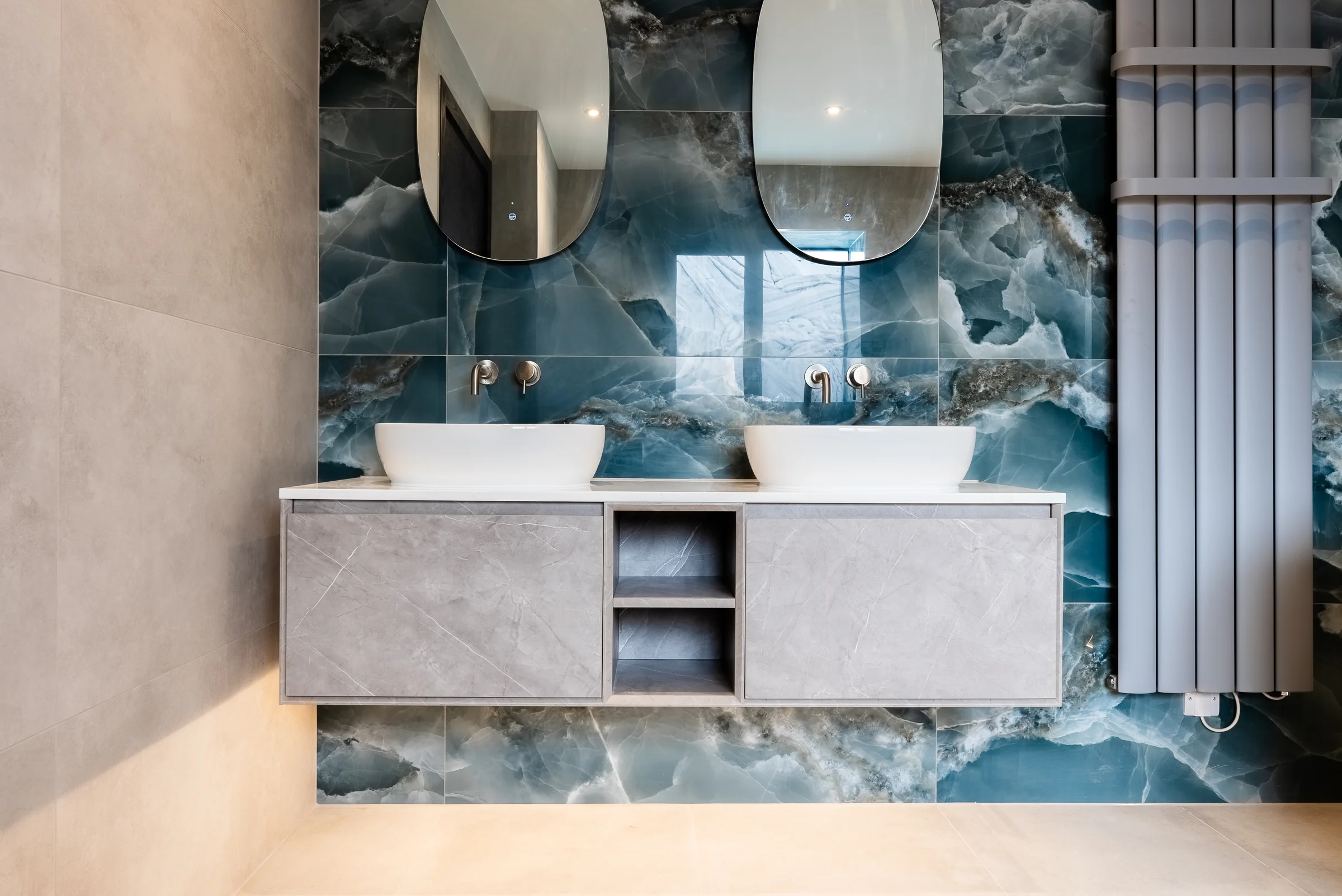Floating vanity double basins blue onyx wall oval mirrors wall taps radiator