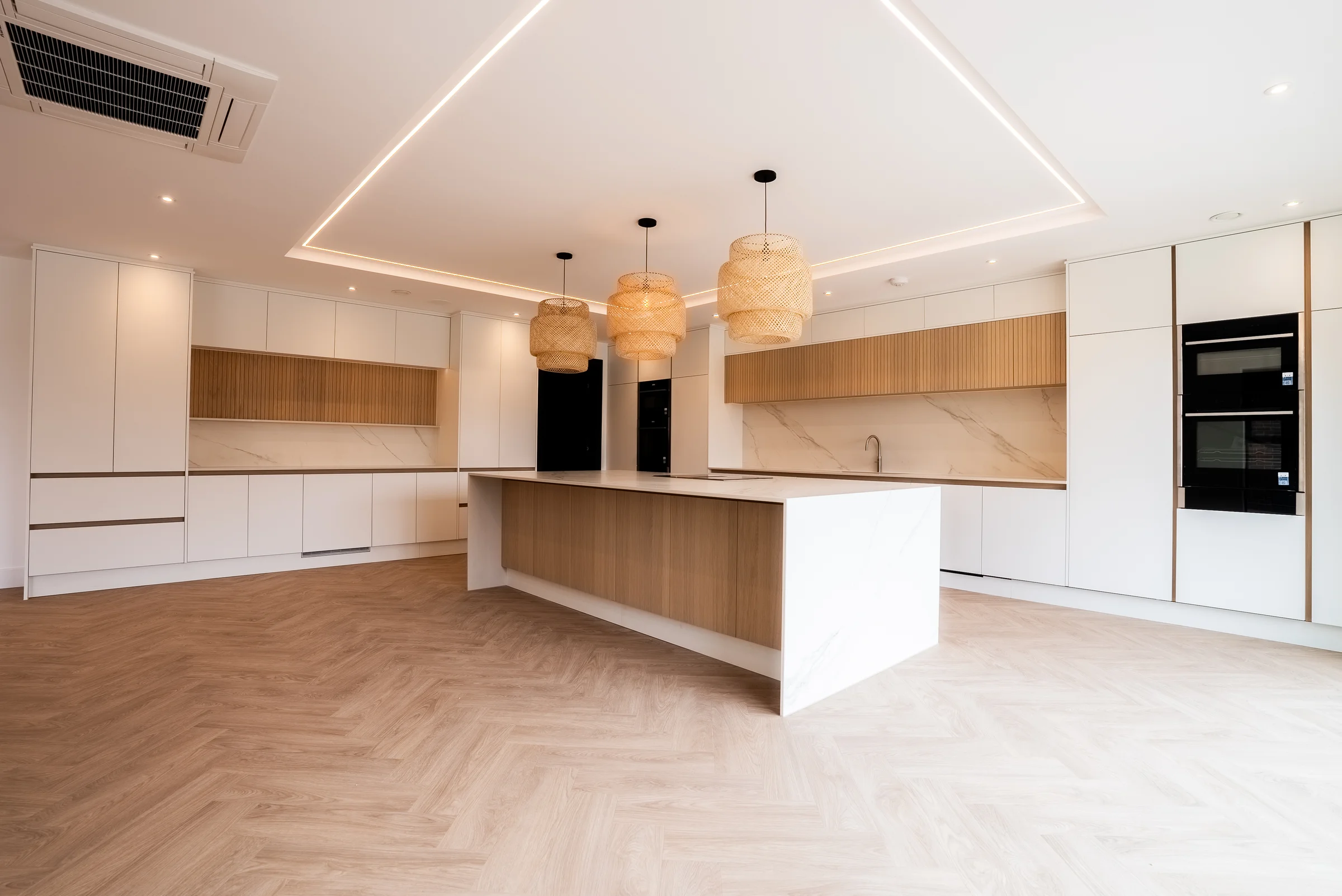 Kitchen opposite angle oak island marble end panel led ceiling black appliances