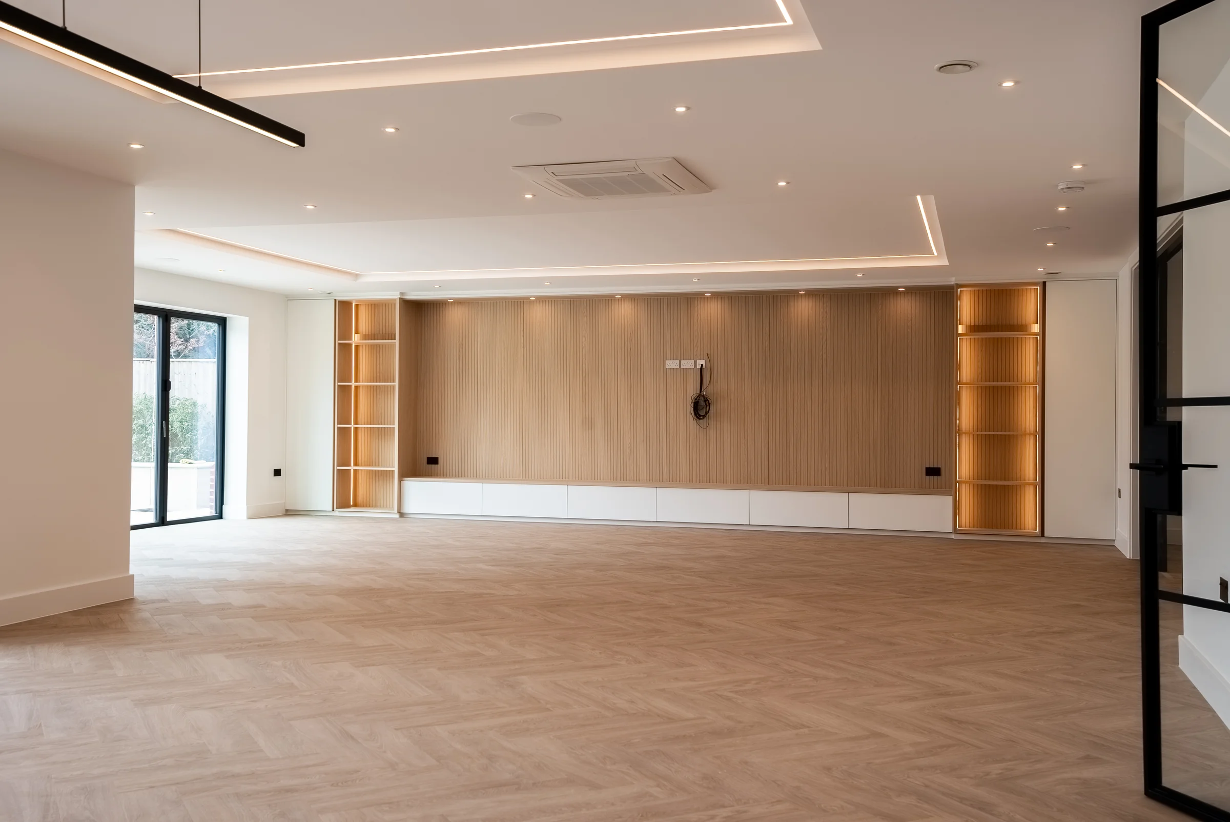 Living space oak slat media wall white low unit led shelves crittall glass doors