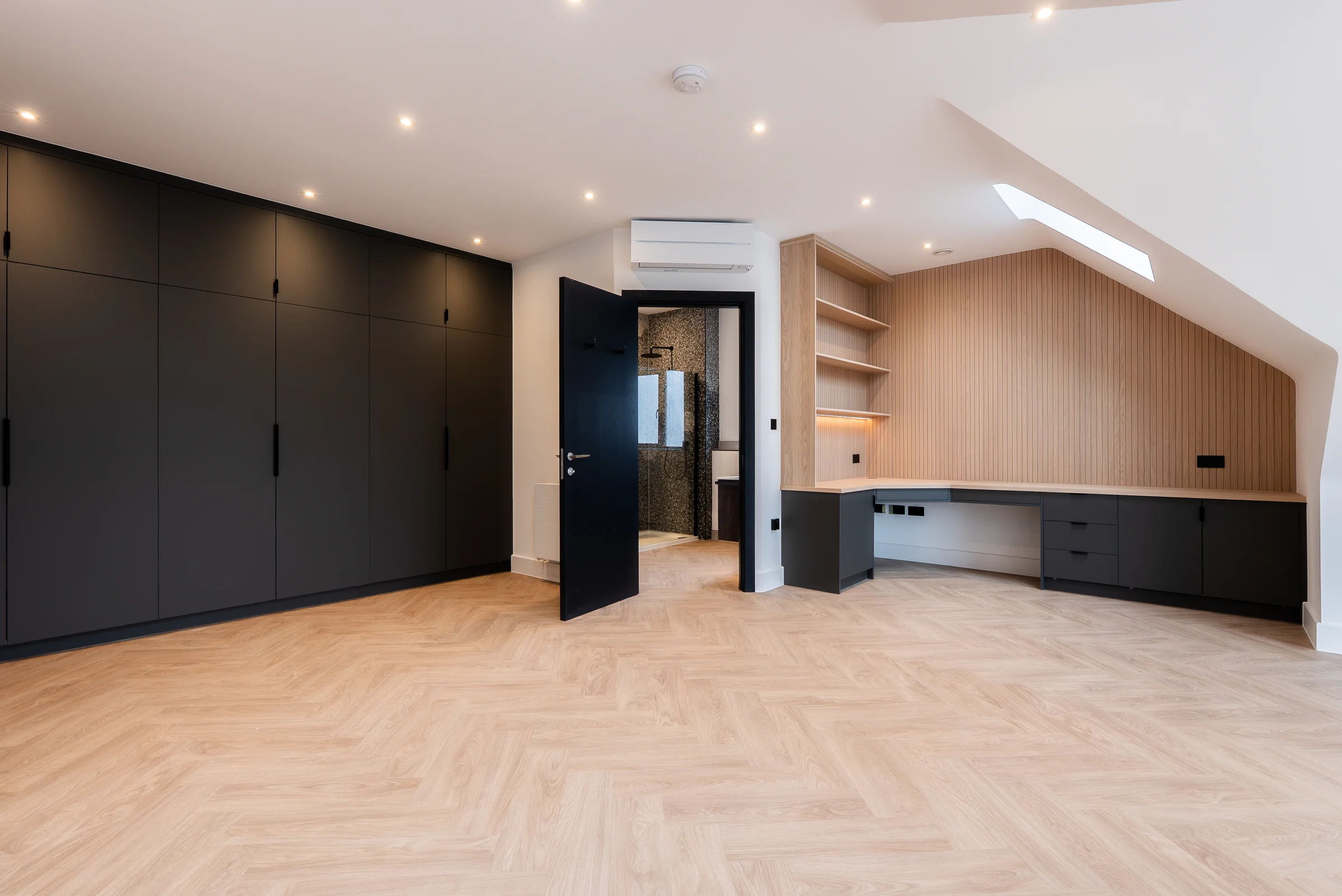 Loft room wide black wardrobes oak slat desk skylight ensuite herringbone