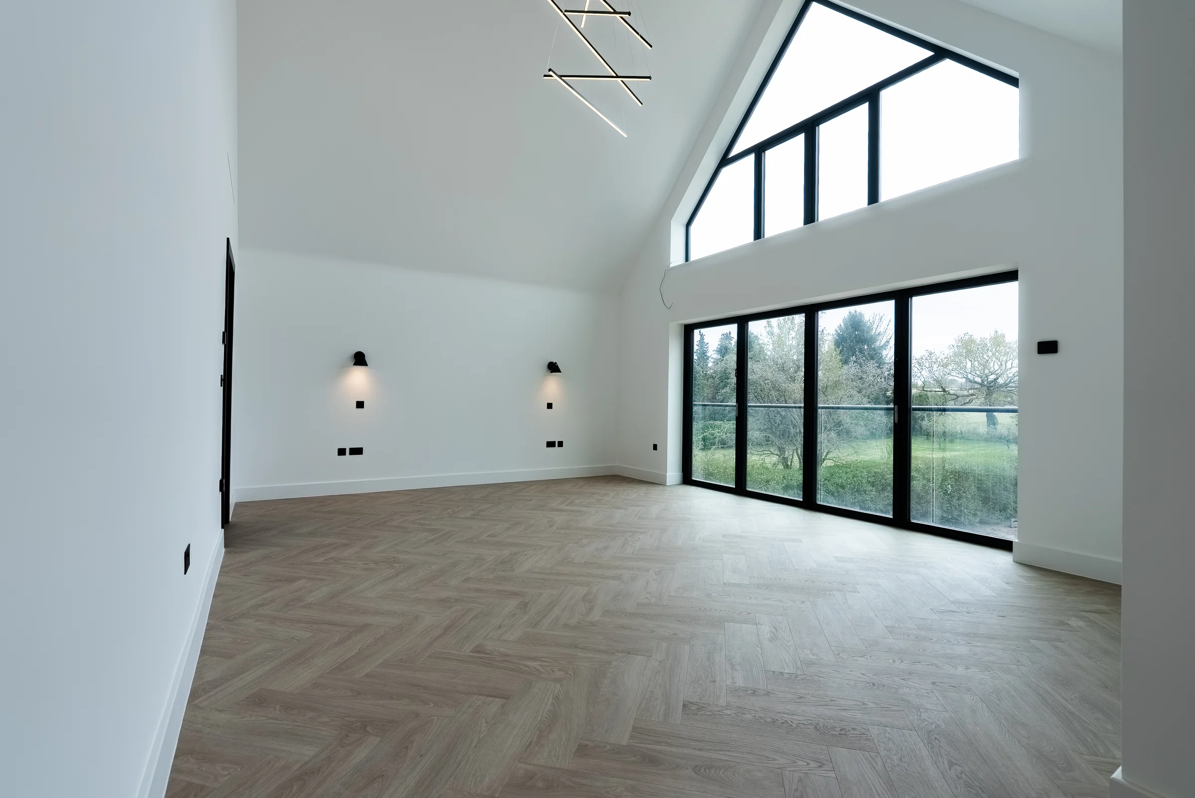 Master bedroom alt angle vaulted gable bifold doors herringbone floor pendant