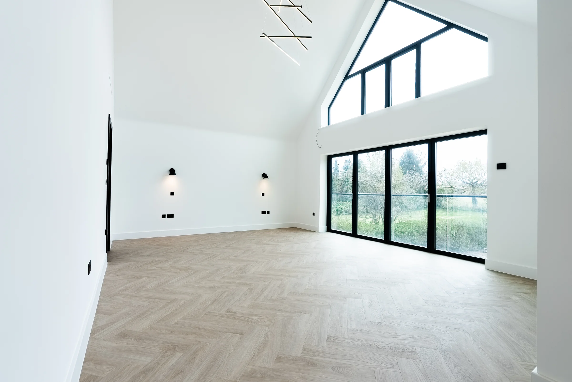 Master bedroom vaulted ceiling gable window garden view modern pendant wall lights