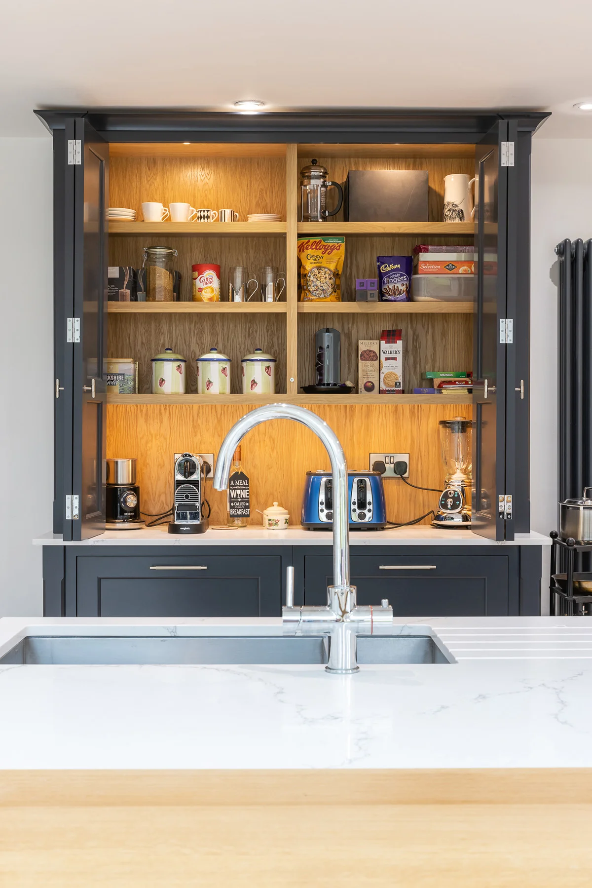 Dark grey pantry cupboard open oak shelves appliances illuminated