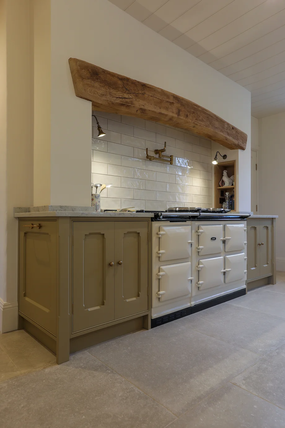 Aga closeup sage flanking units brass pot filler subway tiles beam marble