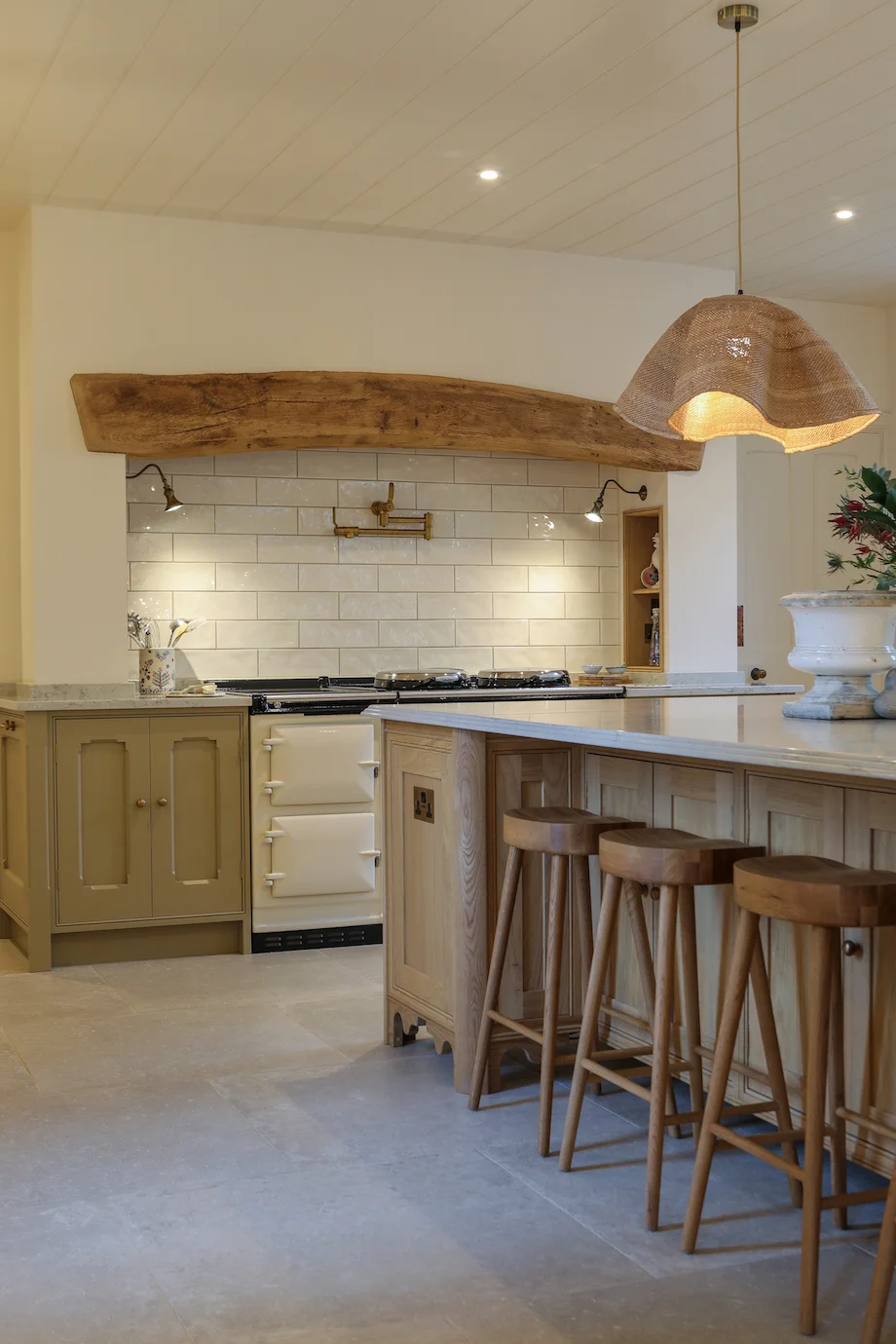 Cream aga rustic beam subway tiles brass pot filler sage units rattan pendant