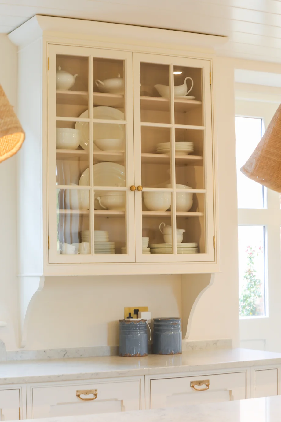 Cream glazed cabinet closeup crockery display corbel brackets