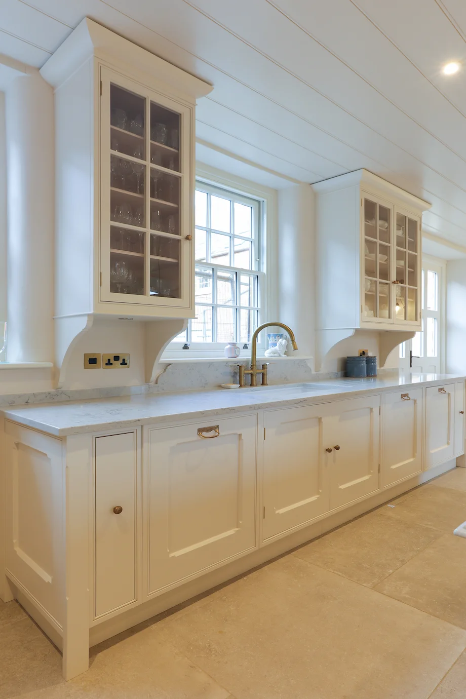 Cream wall run glazed cabinets corbels brass tap marble sash window