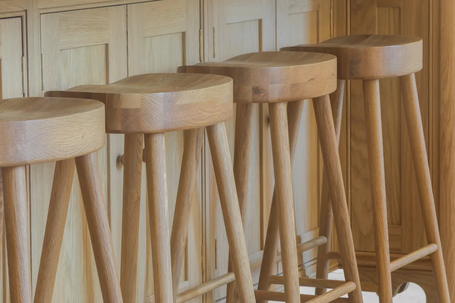 Handcrafted oak bar stools closeup four at island