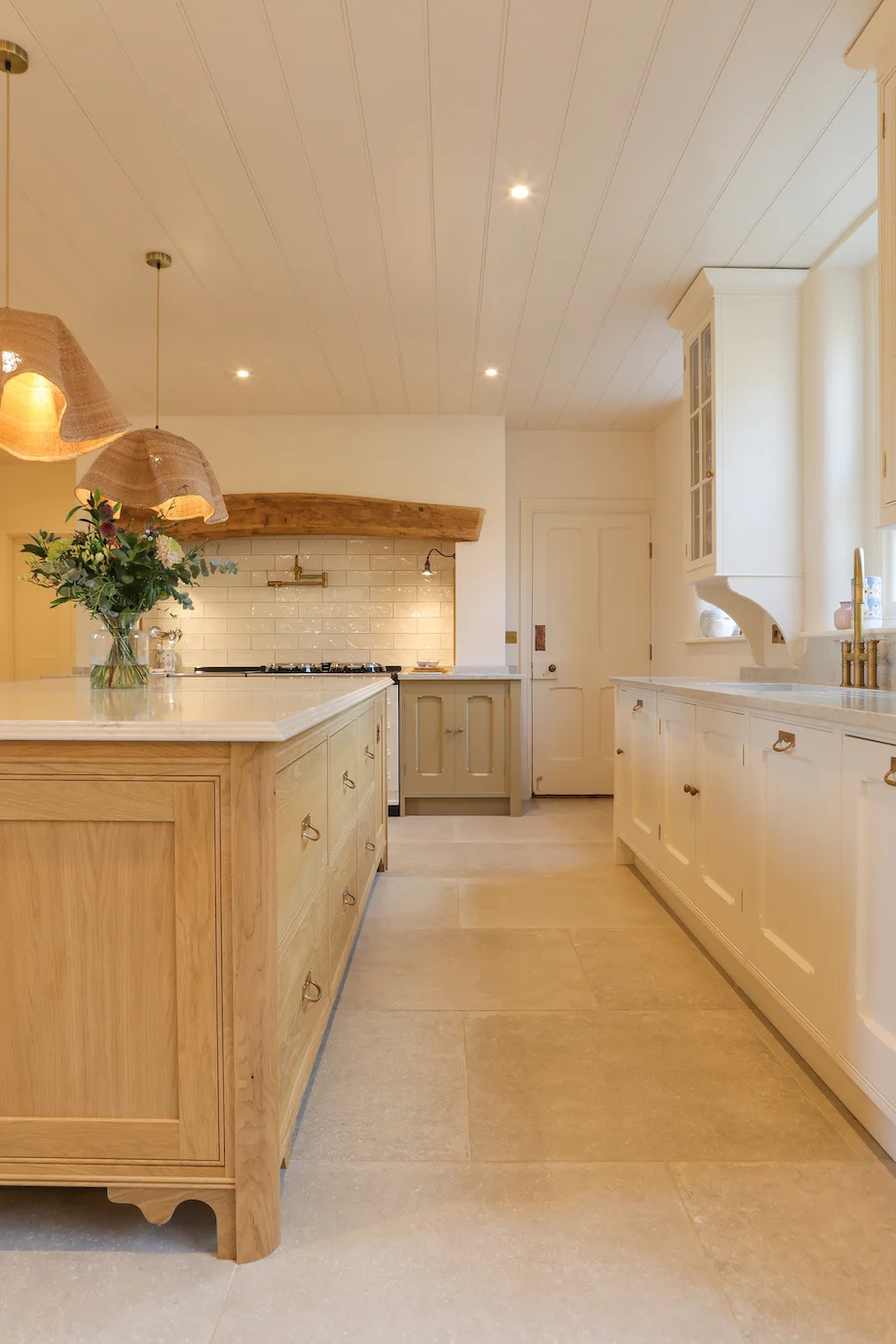 Long view oak island cream units aga beam stone floor