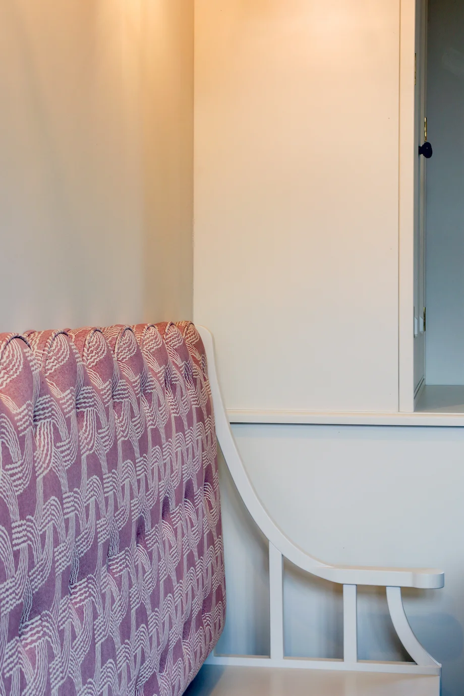 Pink patterned banquette seat back cream cupboard corner