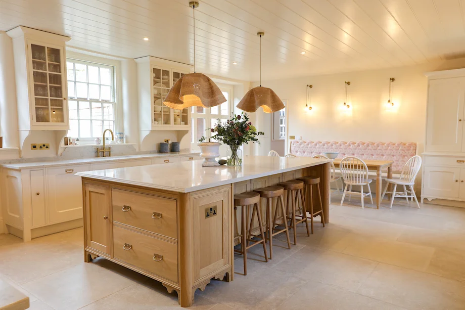 Wide panoramic full kitchen oak island cream units banquette rattan pendants