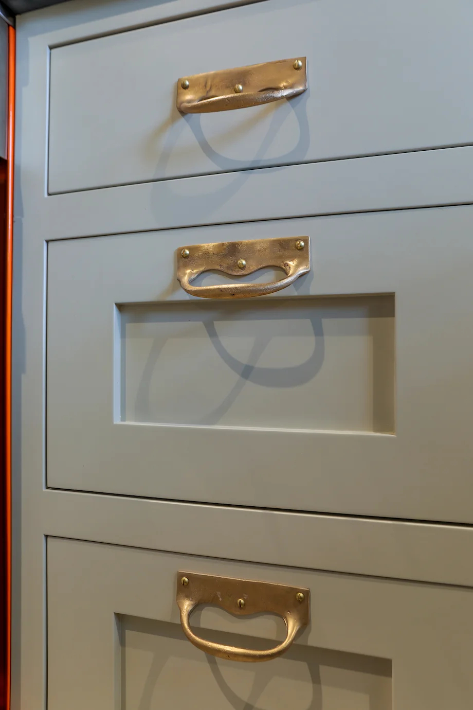Brass drop handles extreme closeup three drawer sizes grey painted shaker