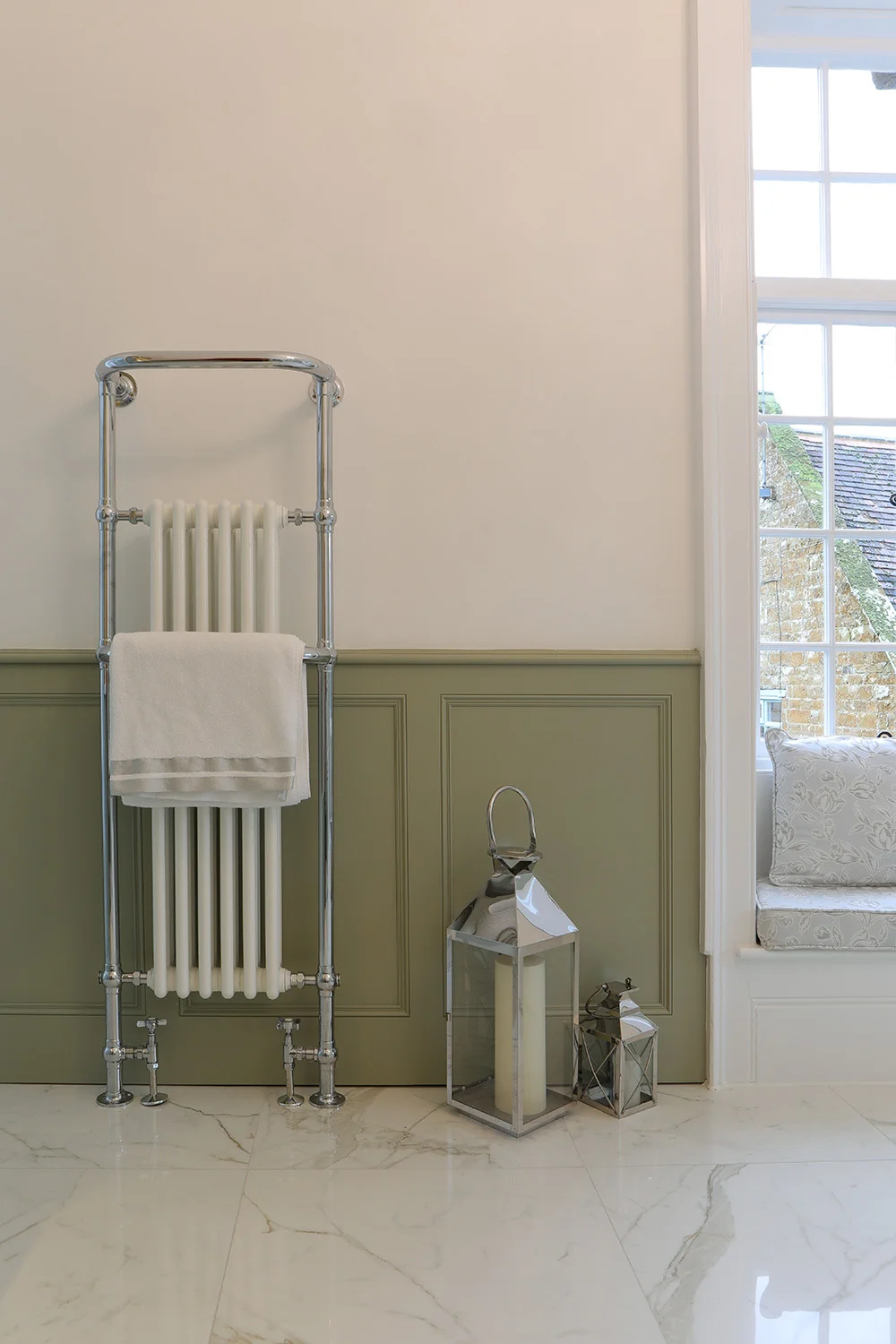 Chrome heated towel rail sage panelling marble floor silver lanterns