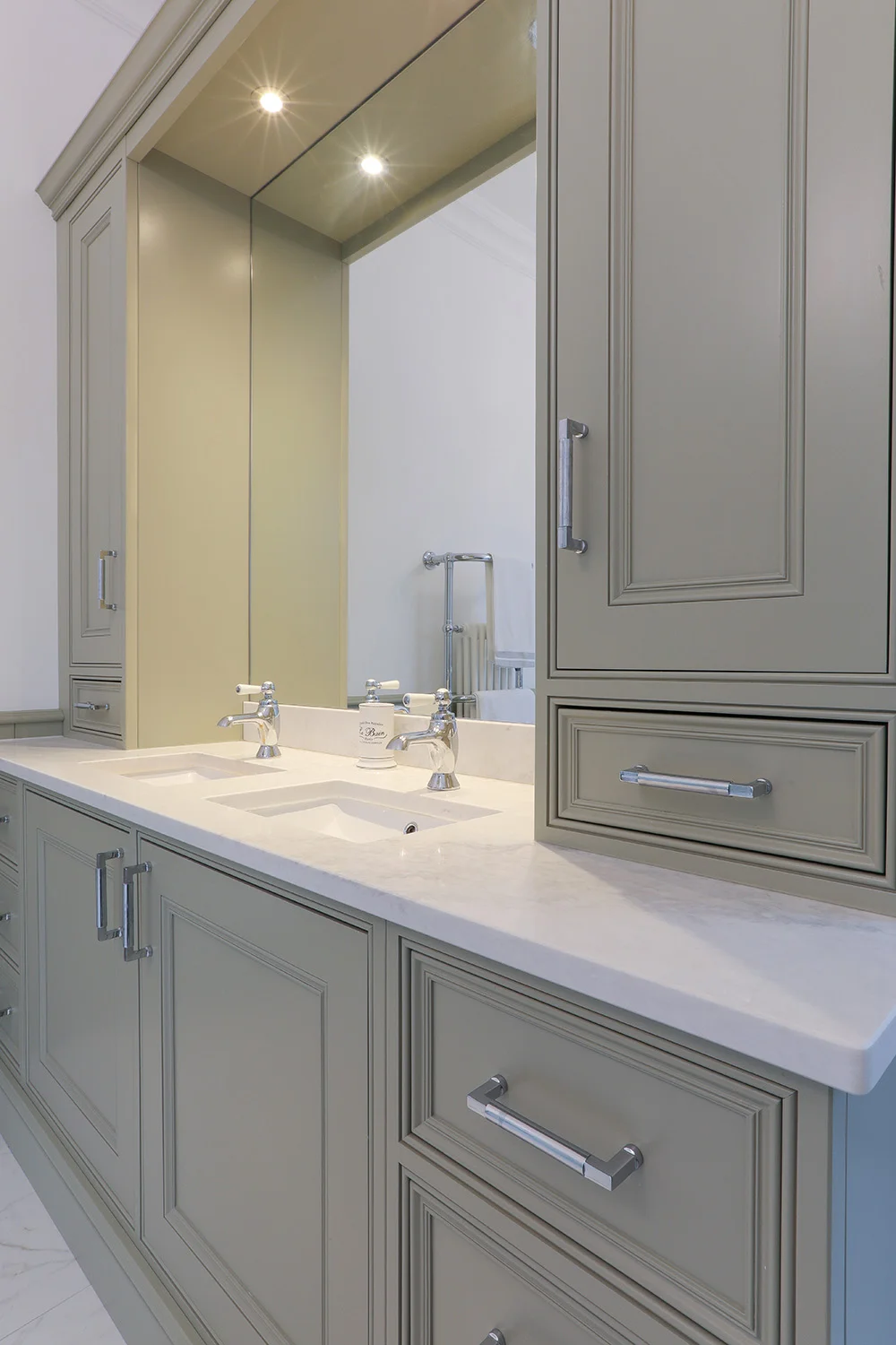 Sage green vanity closeup double basins marble worktop chrome handles mirror