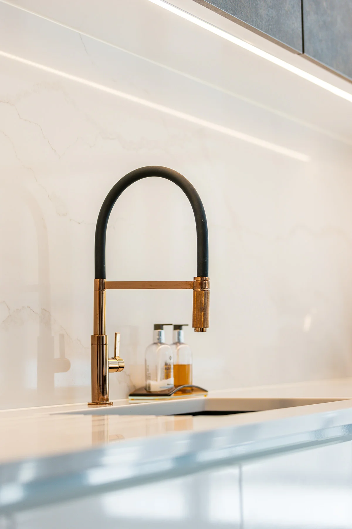 Brass black professional tap closeup quartz splashback led lighting