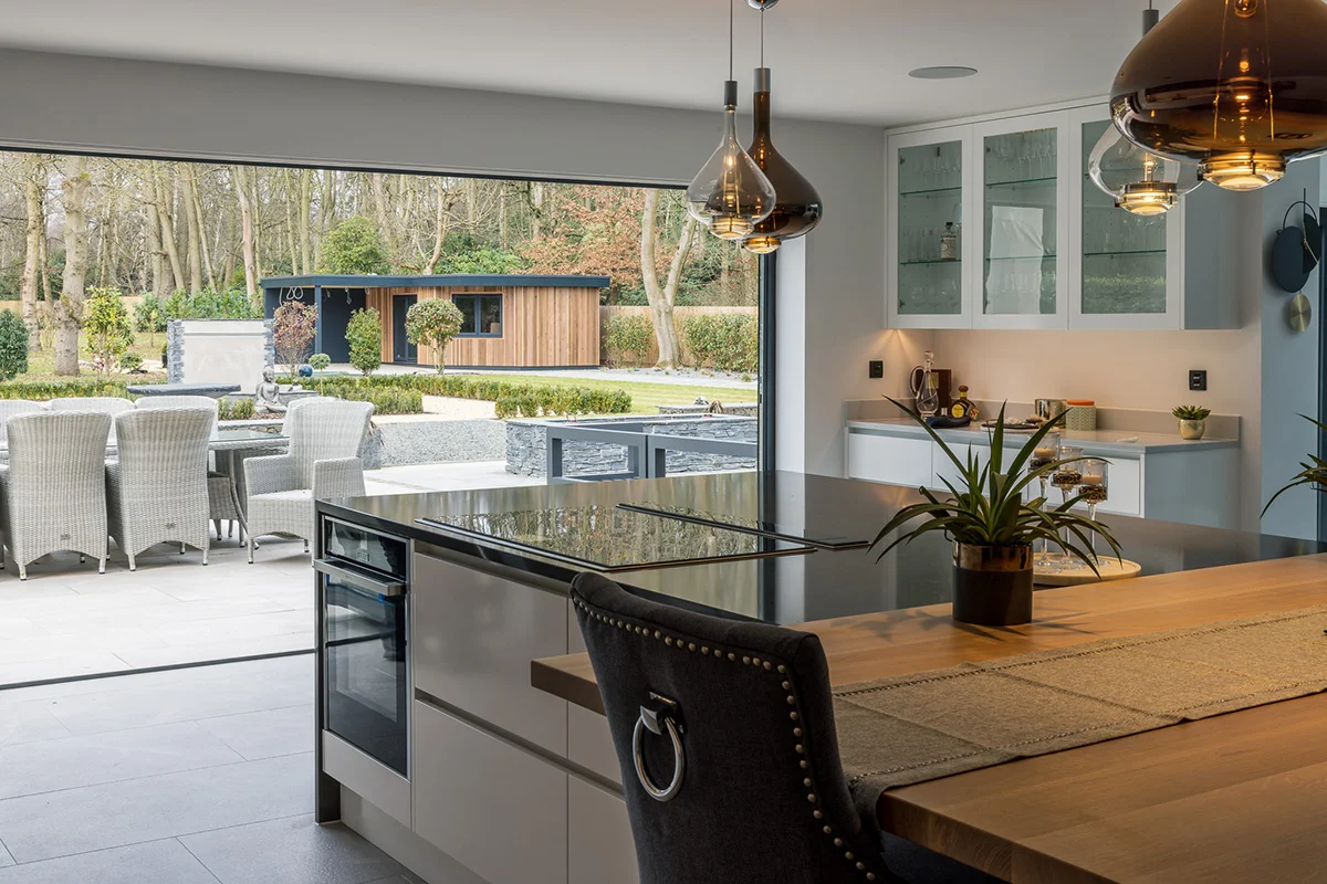 Island bifold doors garden outdoor dining garden room glass cabinet pendants