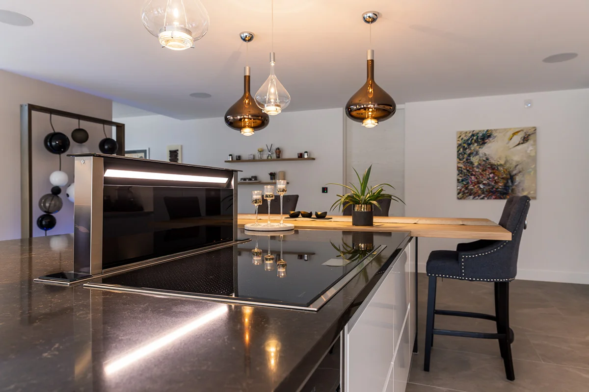 Island downdraft extractor raised black granite copper pendants floating shelves
