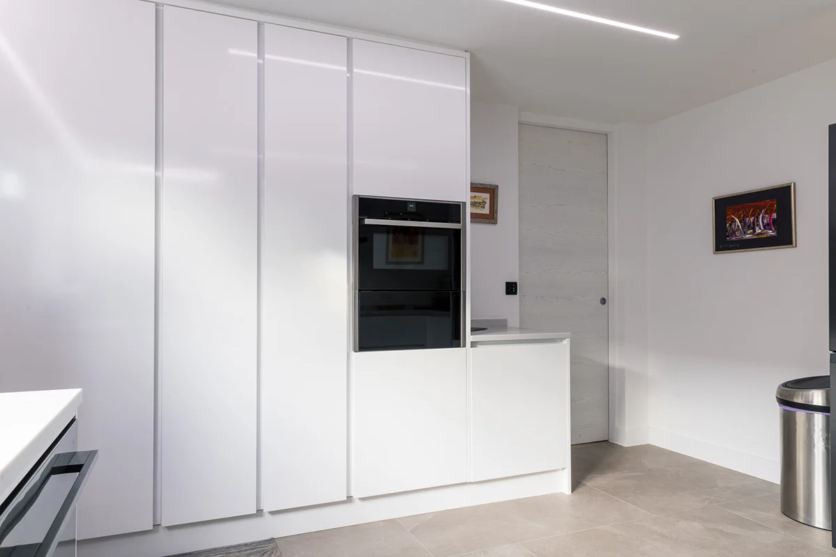 White gloss handleless tall units built in oven microwave led ceiling