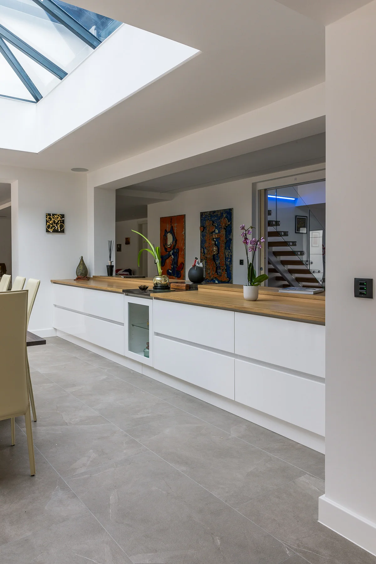 White handleless sideboard oak top glass niche skylight staircase orchid