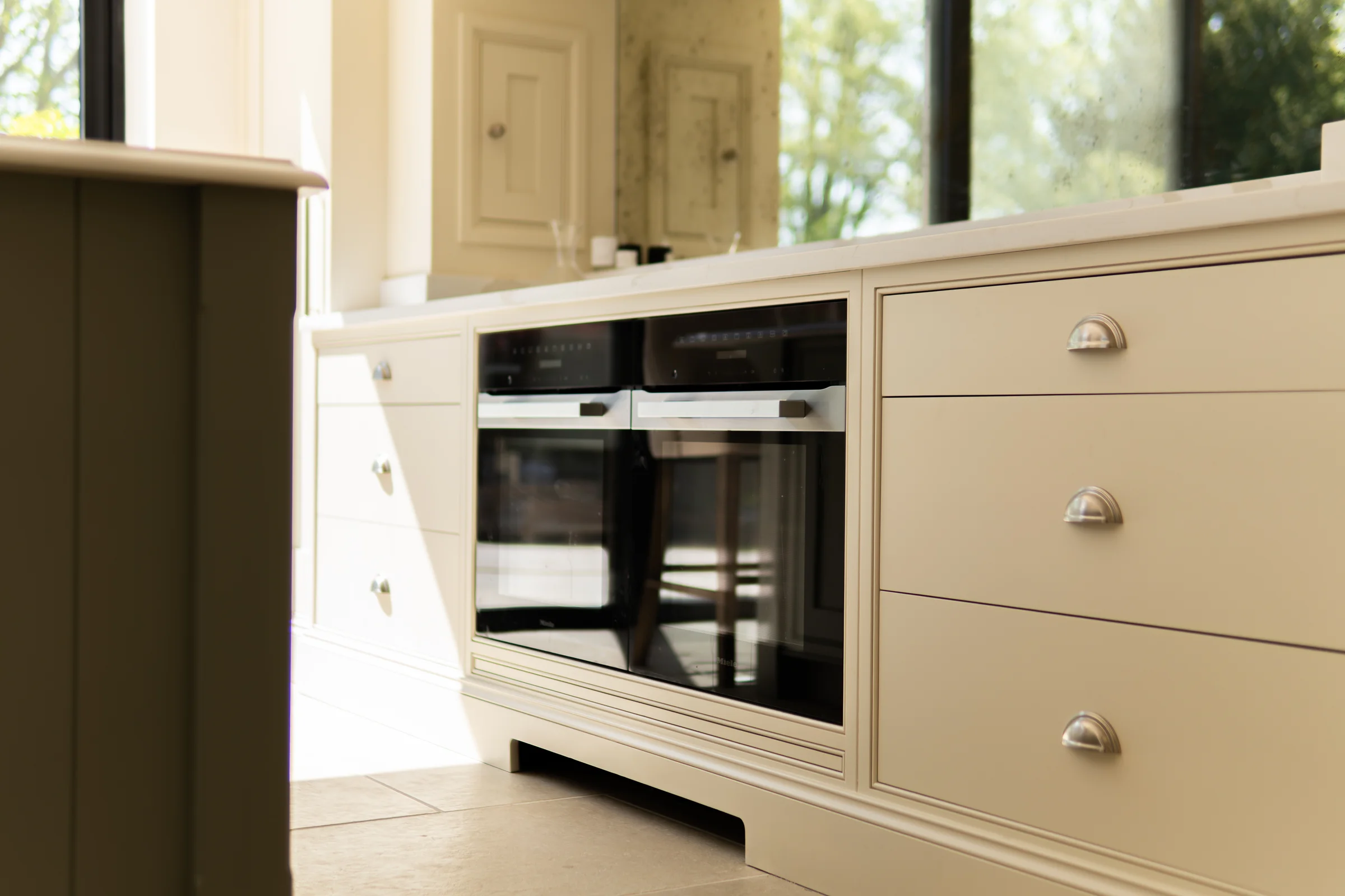 Cream base units double miele ovens cup handles antiqued mirror sage island edge