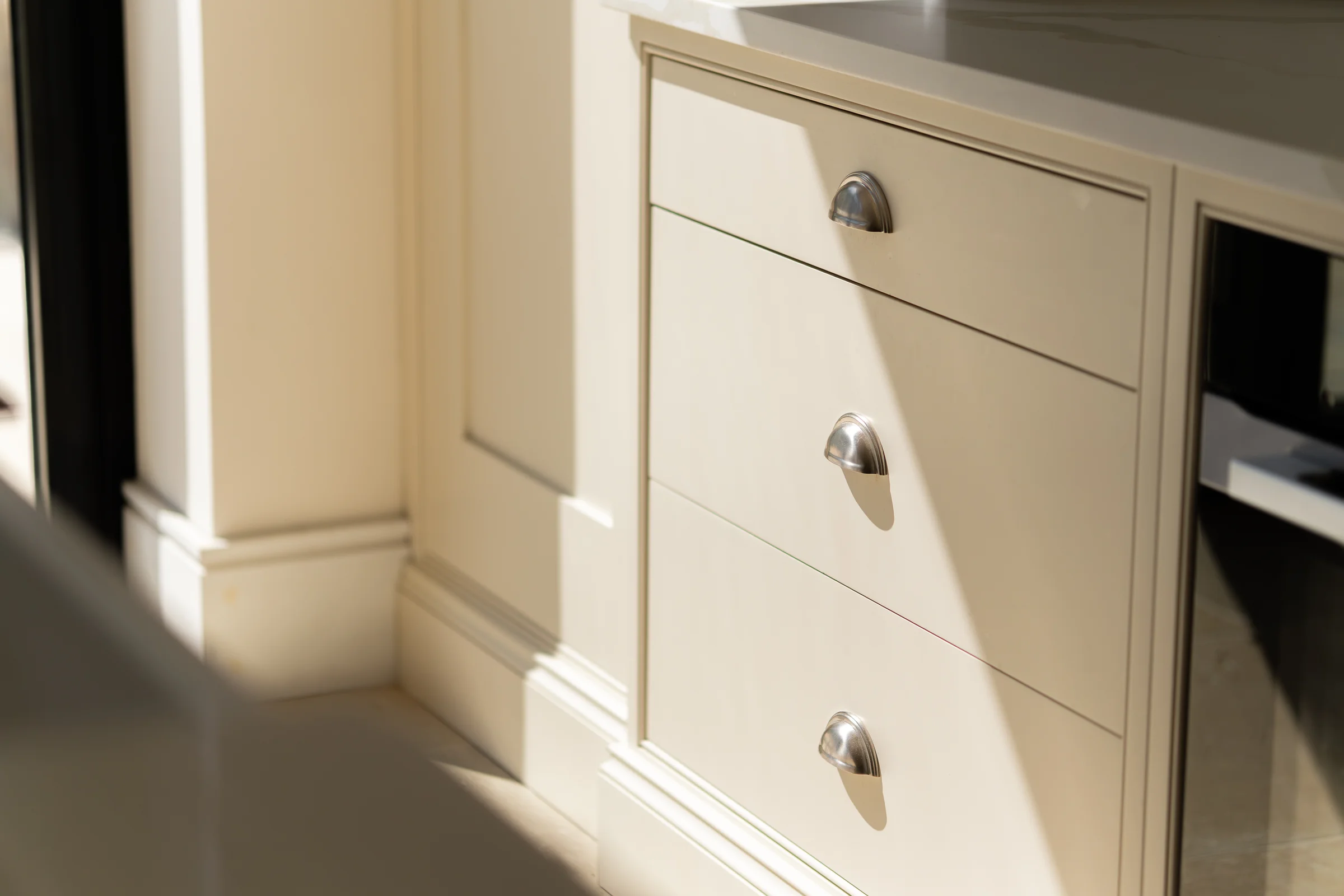 Cream shaker drawers nickel cup handles sunlight quartz worktop oven edge