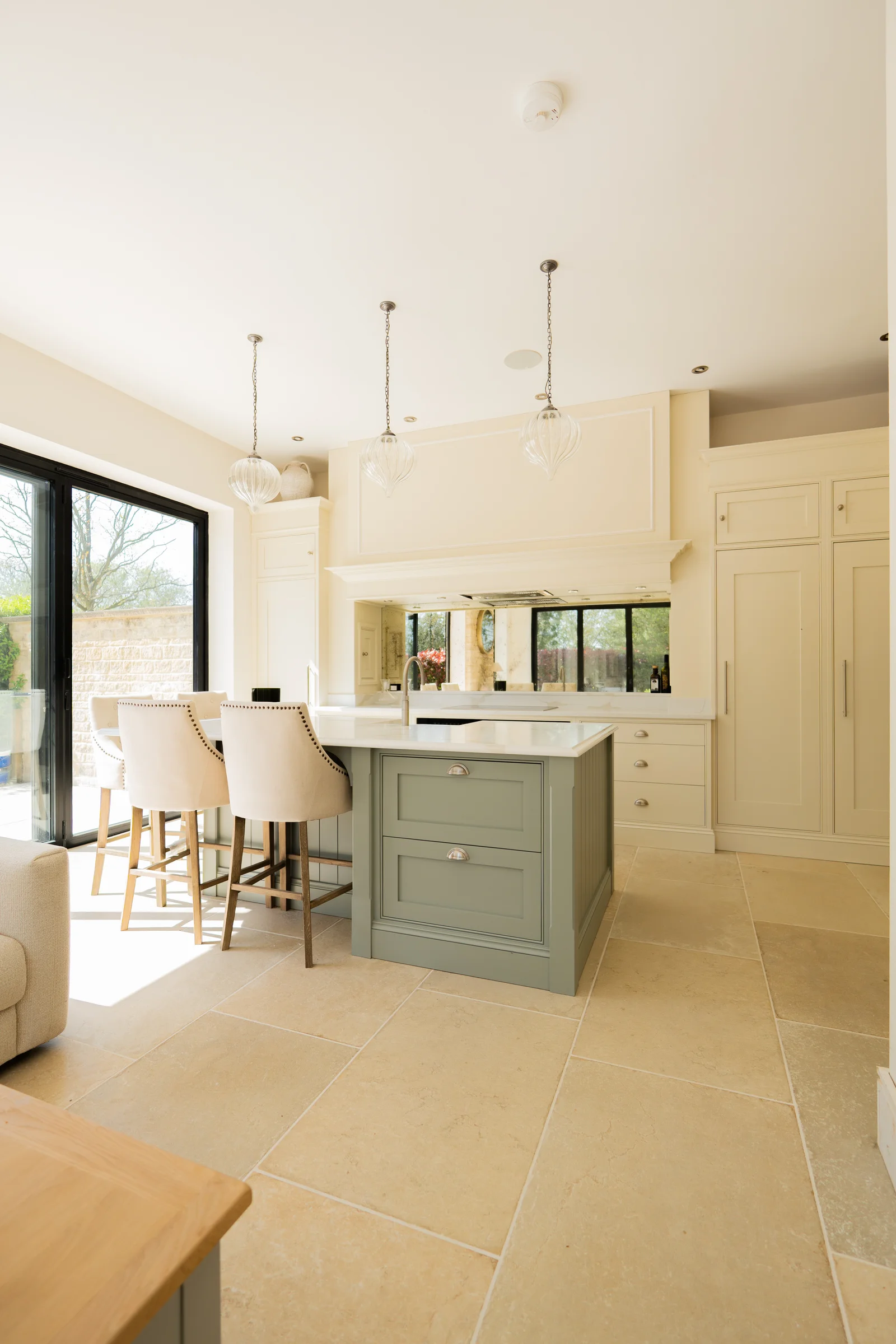 Portrait entrance sage island drawers bar stools pendants cream units mirror mantel limestone