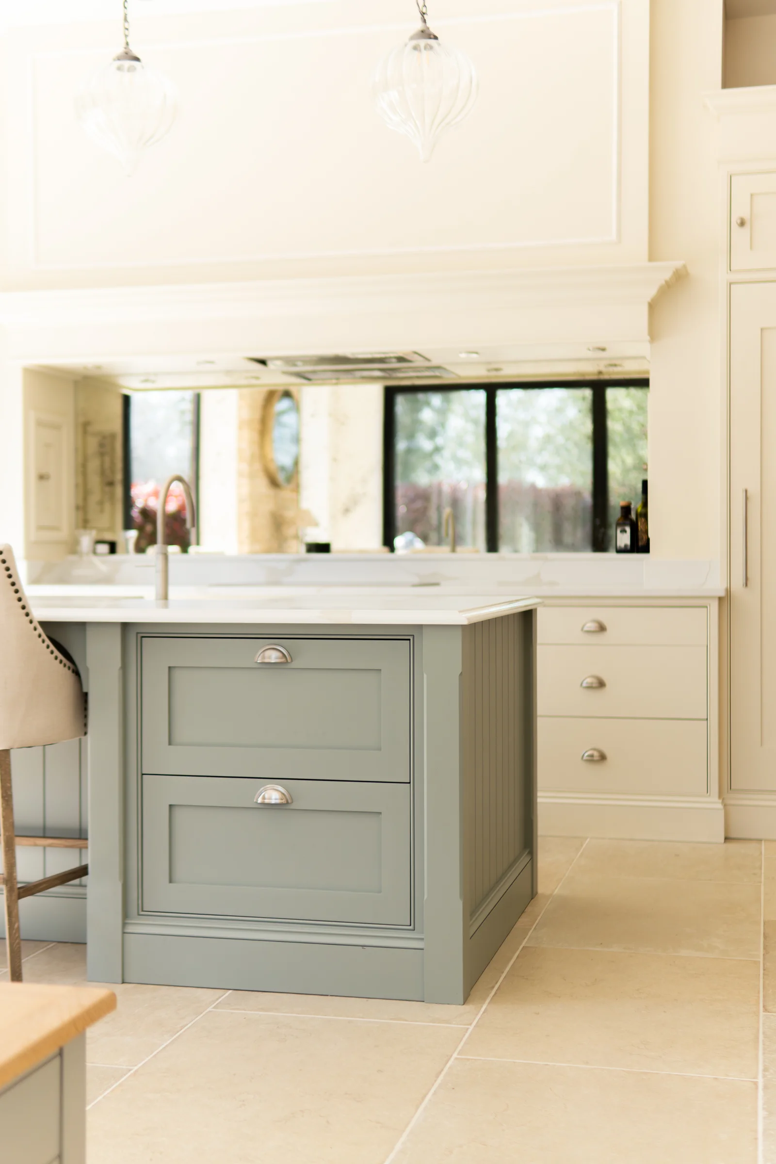 Sage island end shaker drawers cup handles glass pendants cream units limestone