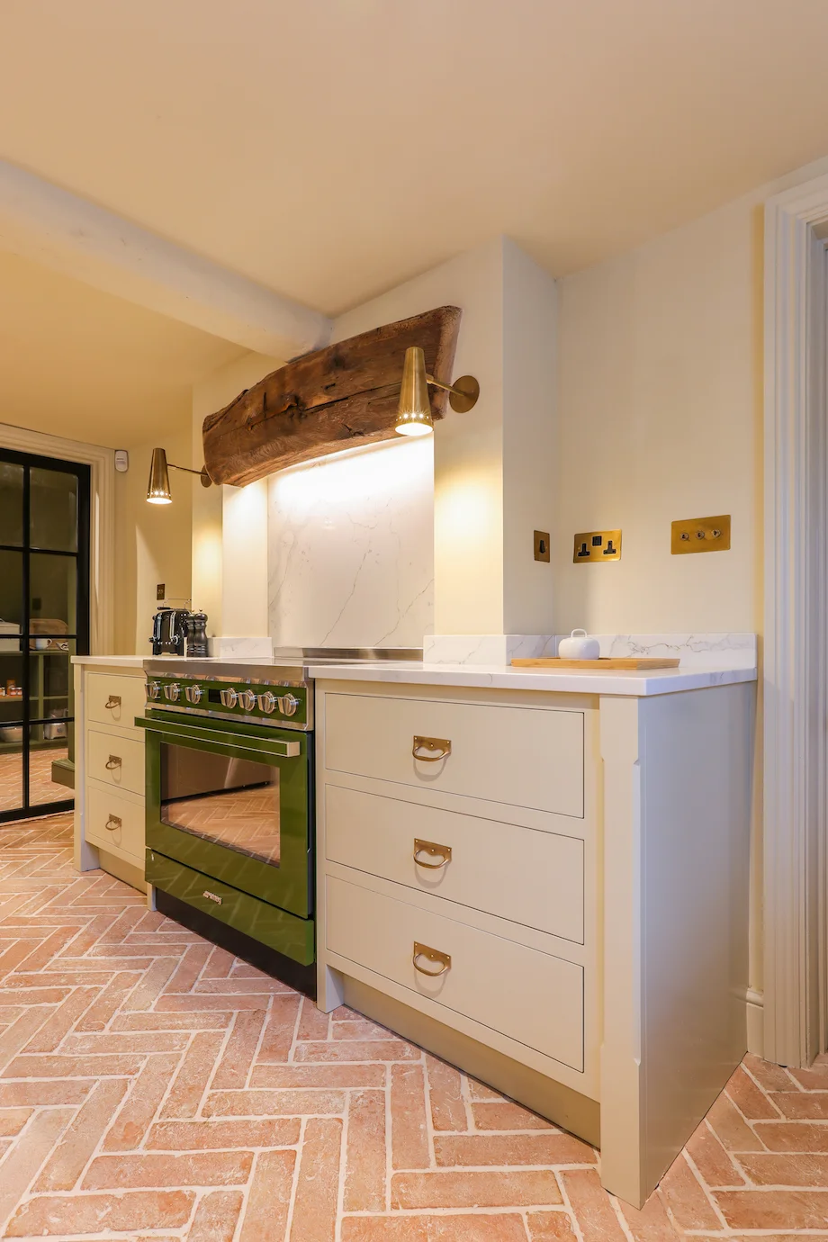 Green range cooker rustic beam brass wall lights quartz splashback cream drawers