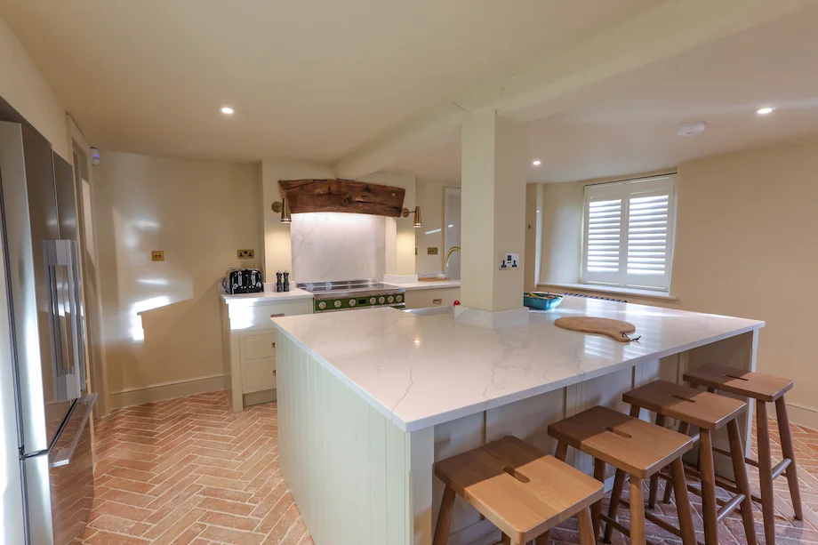 Wide kitchen view island stools range cooker beam shuttered window fridge