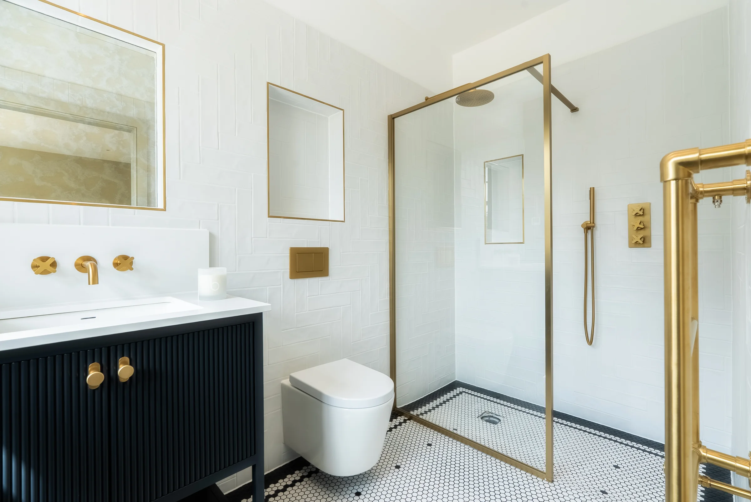 Bathroom navy reeded vanity brass shower screen hexagonal floor herringbone tiles towel rail
