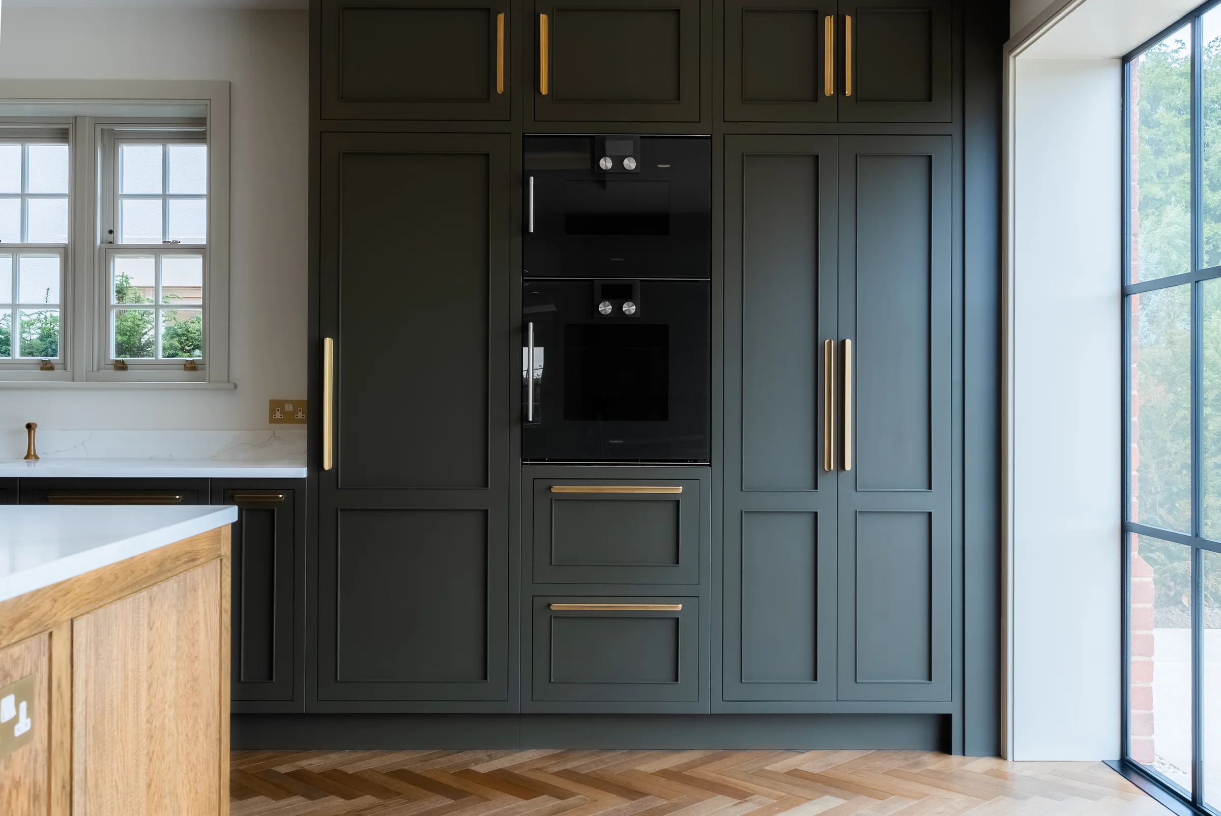 Charcoal tall units built in black double ovens brass handles casement crittall