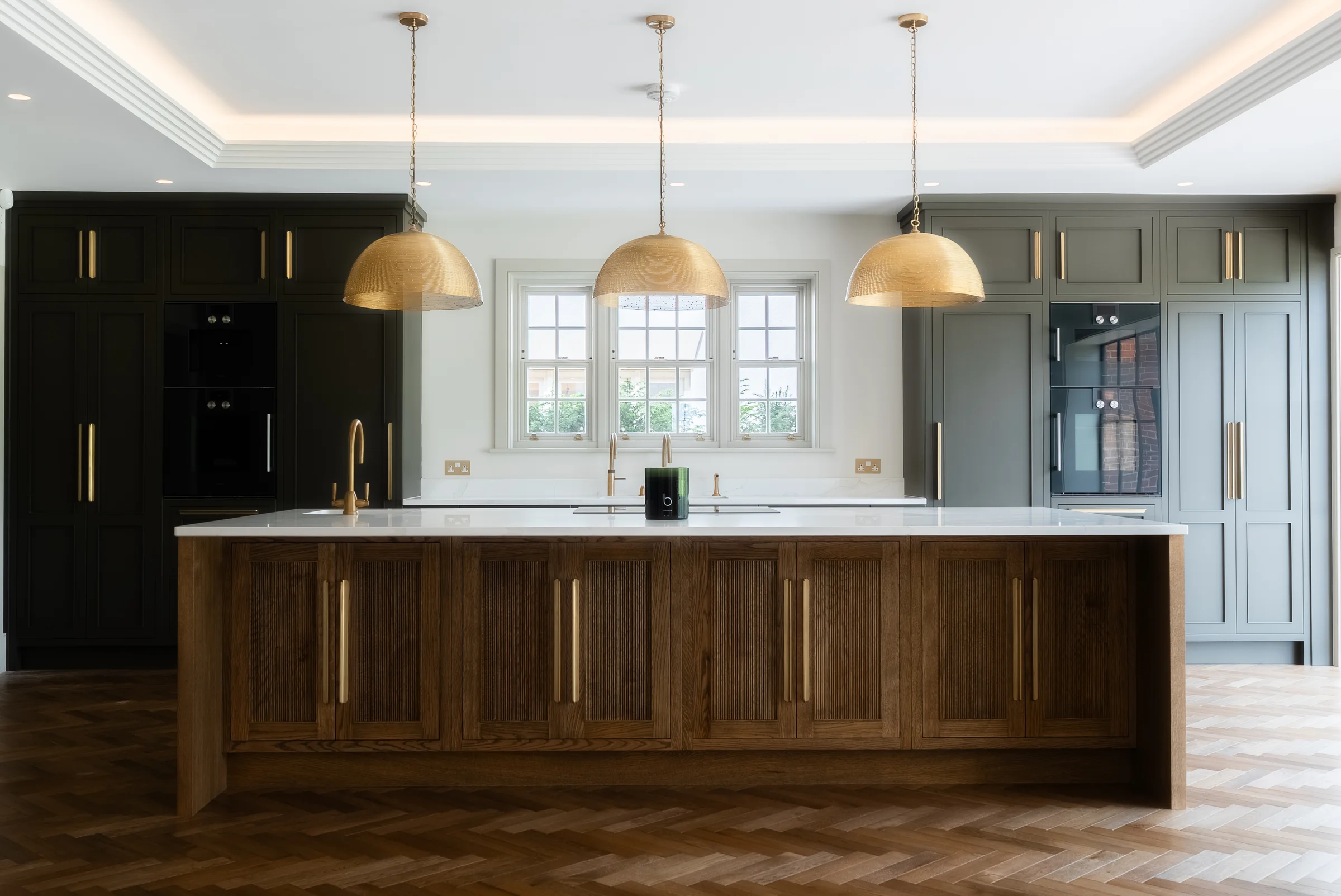Front on island dark oak shaker brass handles dome pendants charcoal grey units coffered