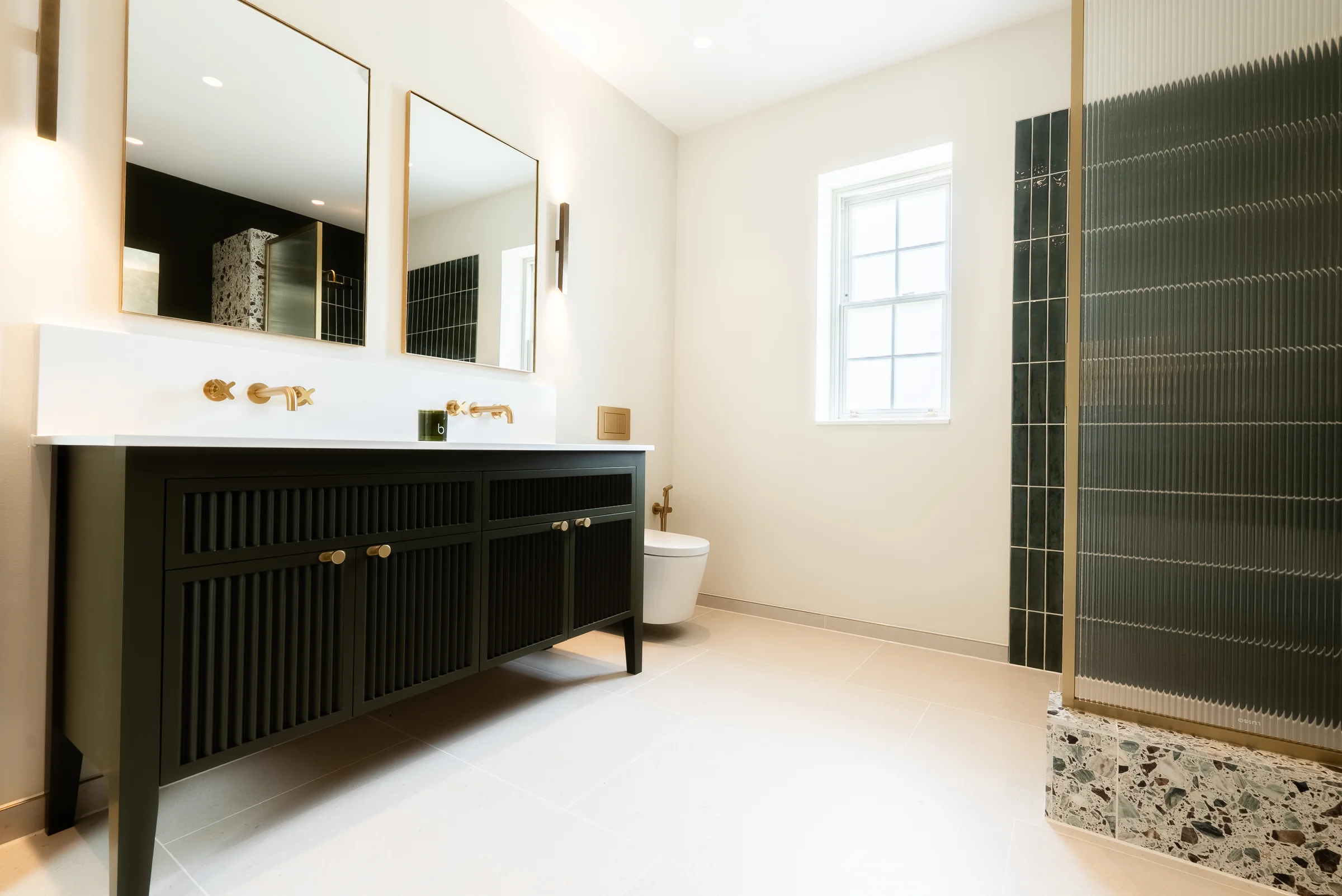 Full bathroom dark green reeded vanity mirrors shower terrazzo base reeded glass