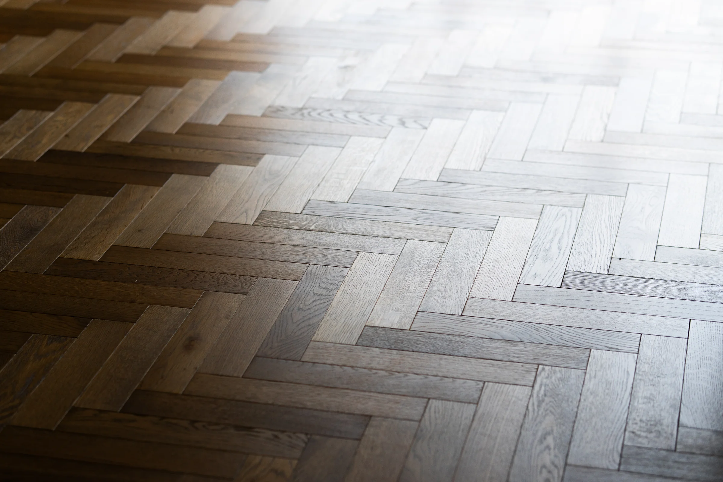Herringbone parquet oak floor closeup sunlight streaming