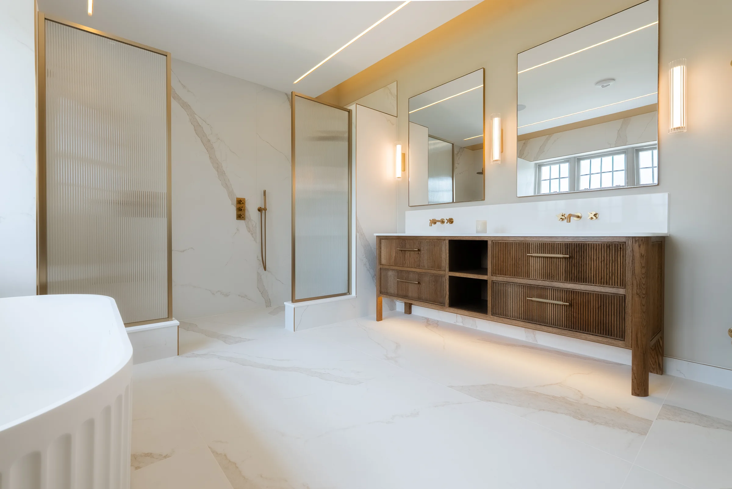 Master ensuite fluted bath dark oak reeded vanity brass mirrors marble reeded glass shower