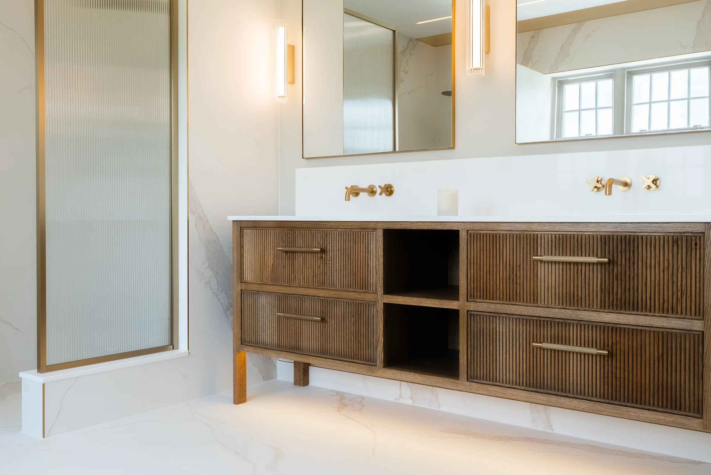 Vanity closeup dark oak reeded drawers brass handles open cubby brass taps mirrors