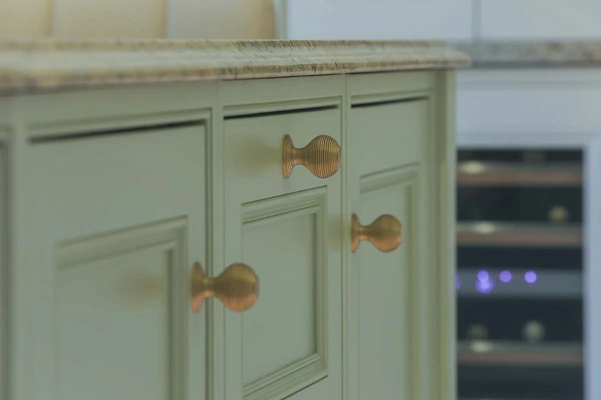 Brass reeded knobs closeup duck egg green painted panel doors granite