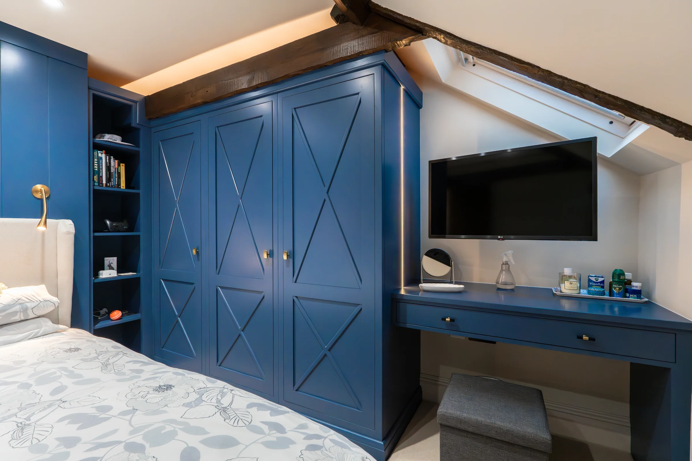 Bedroom blue x pattern wardrobes matching desk tv brass knobs led strip beam eaves