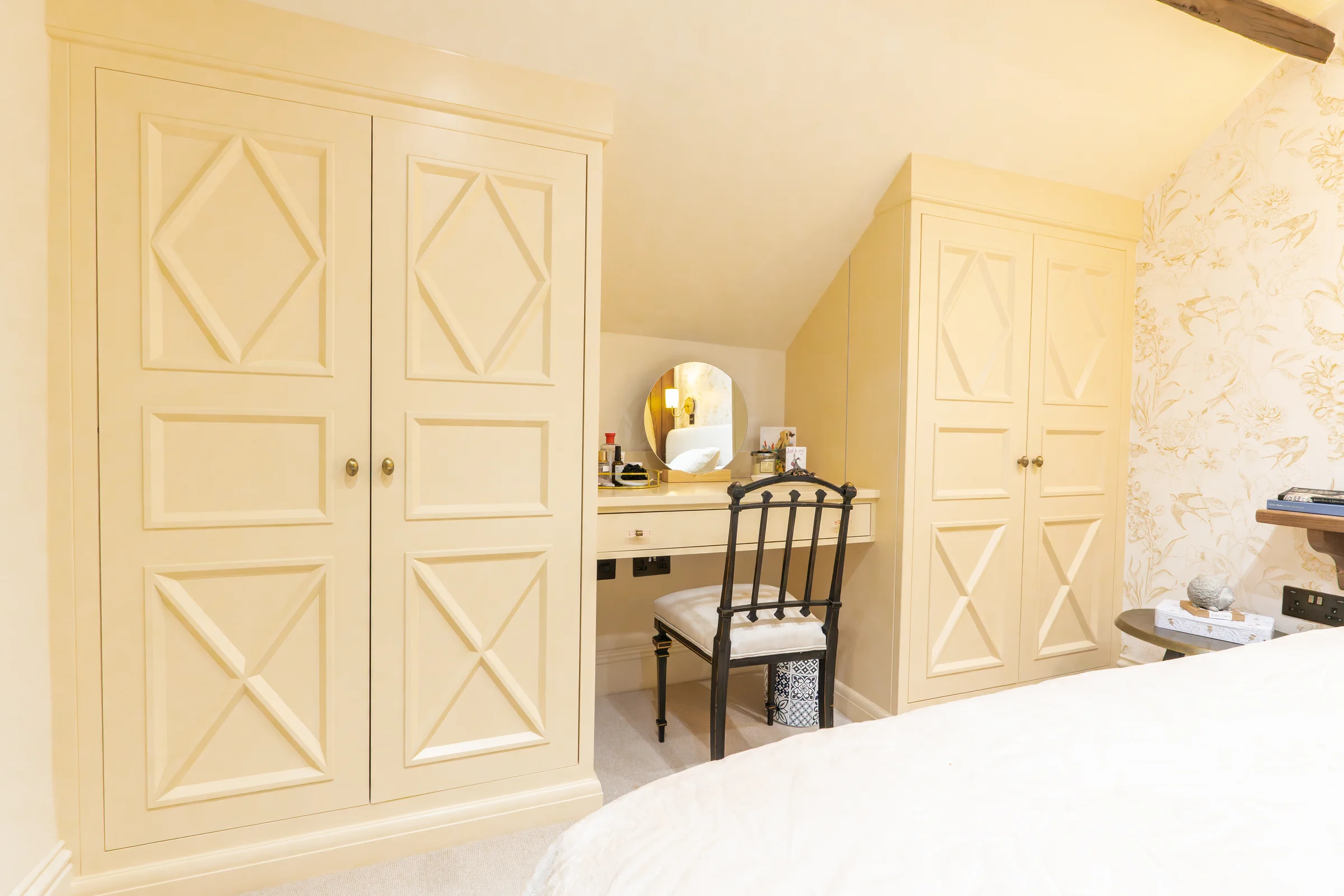 Bedroom cream x pattern wardrobes dressing table nook brass knobs floral wallpaper beam