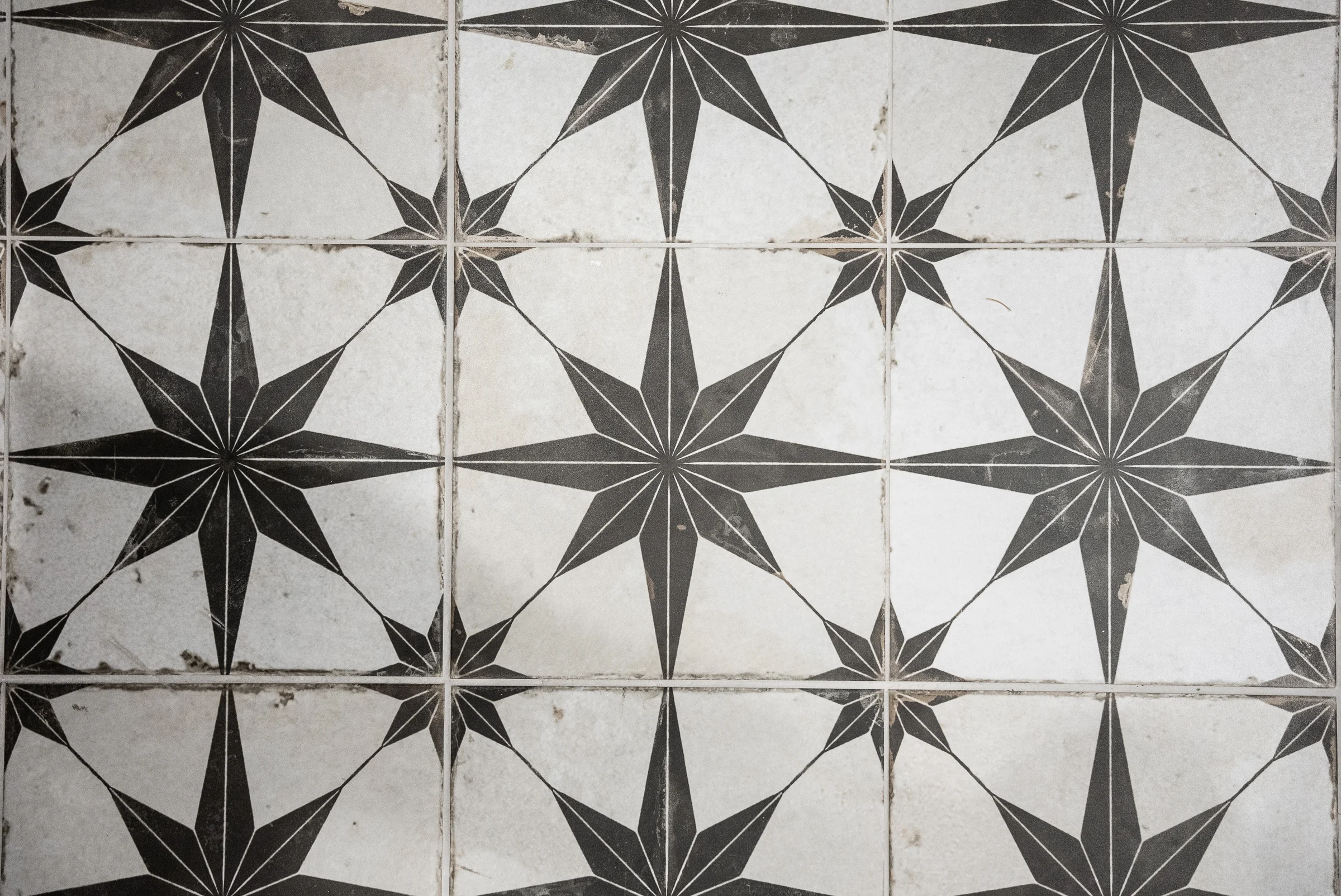 Closeup black white star motif floor tiles detail