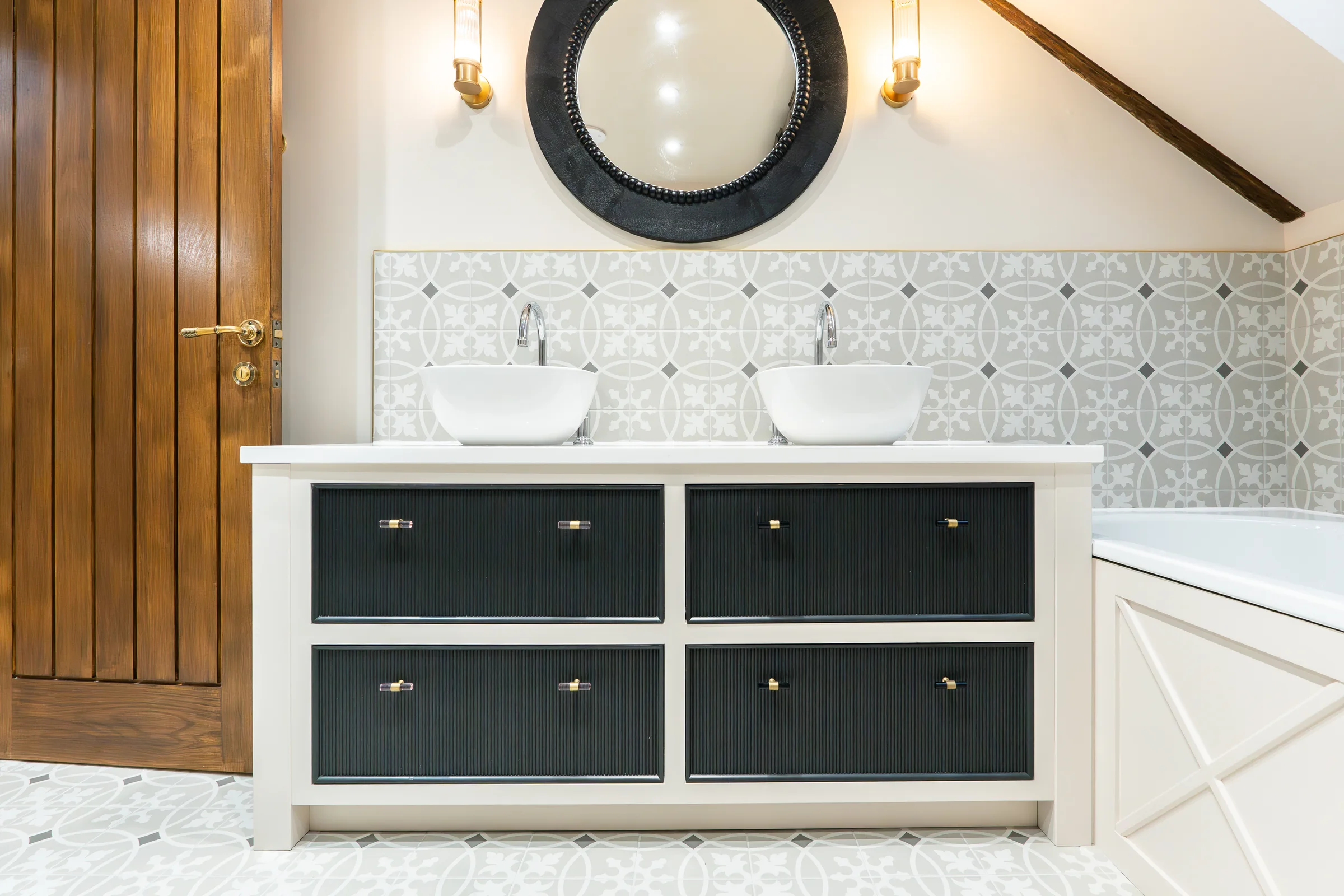 Double vanity front on navy reeded drawers vessel basins black mirror brass lights walnut door