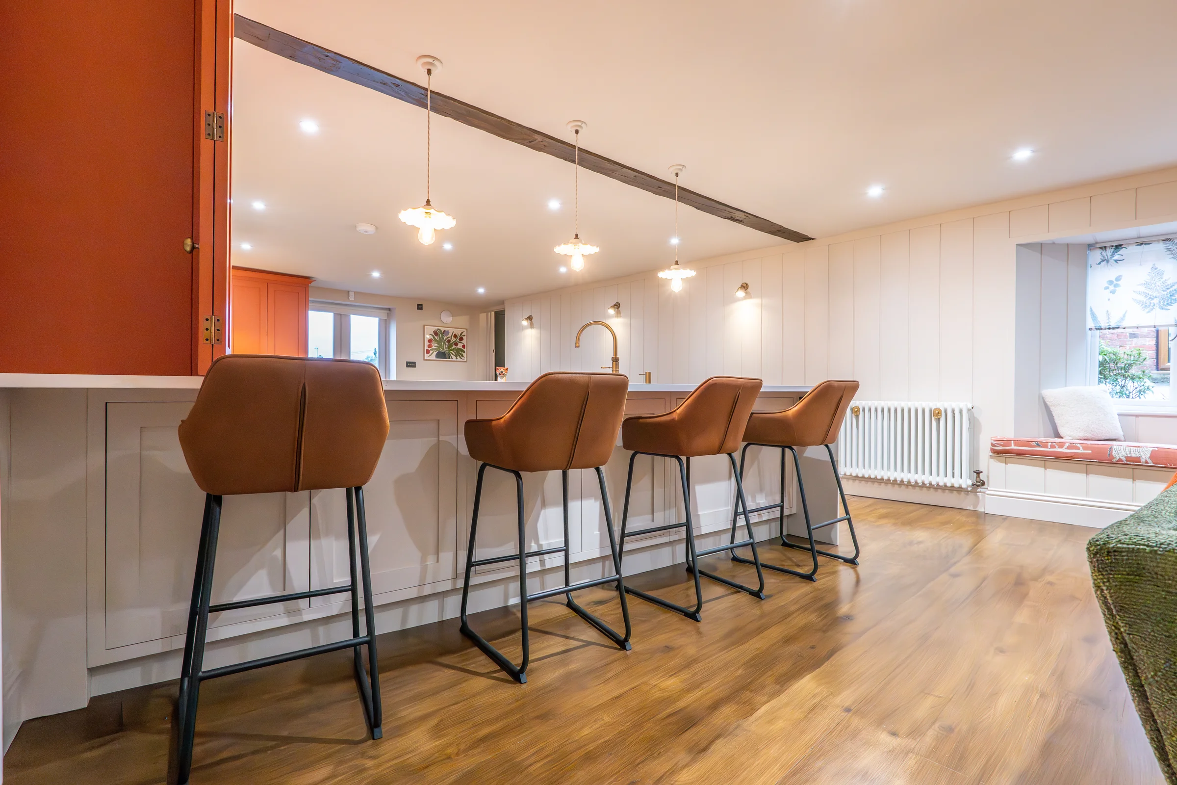 Island seating tan leather bar stools white shaker orange dresser pendants beam panelling