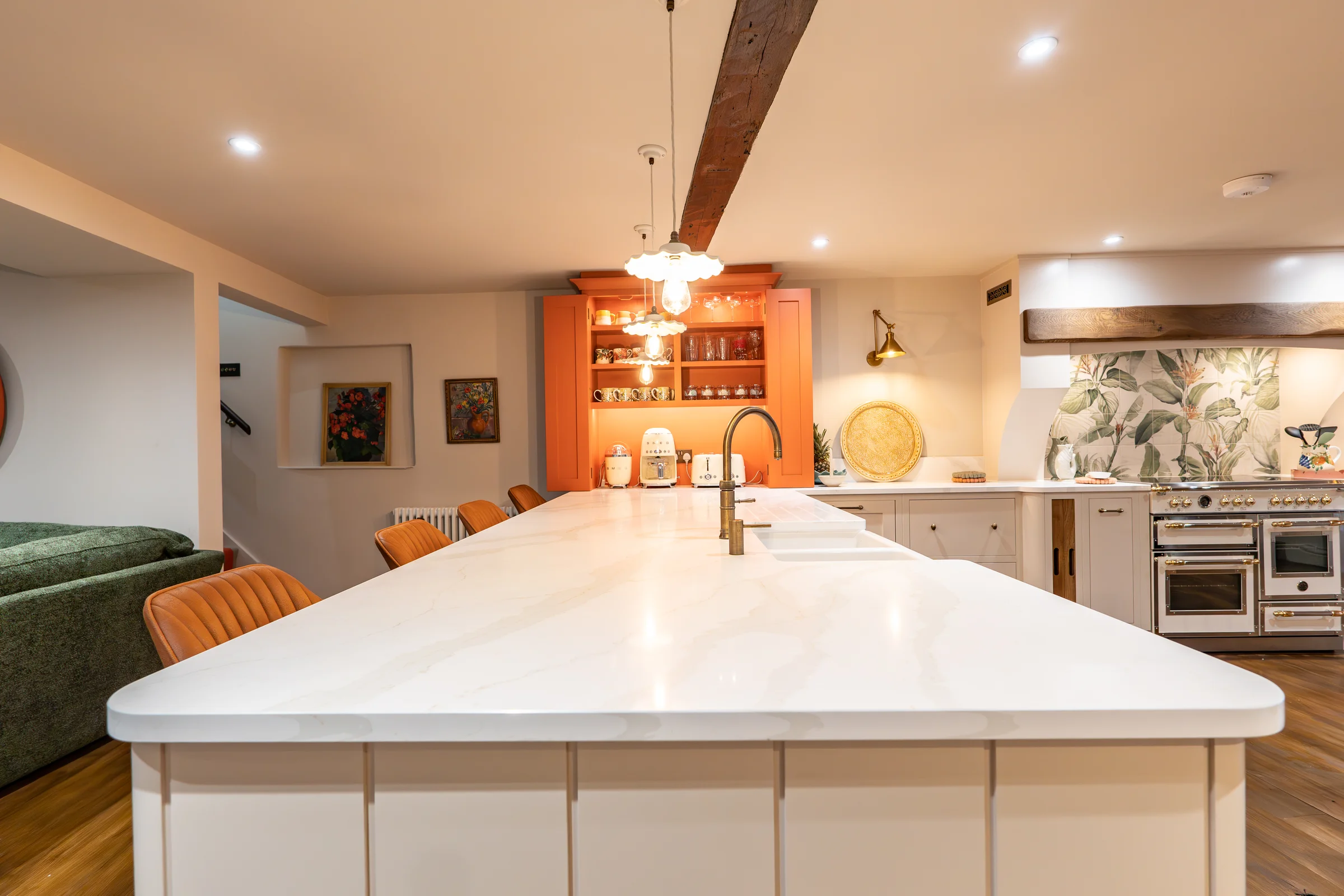 Island worktop view white quartz brass tap pendants orange dresser tan bar stools