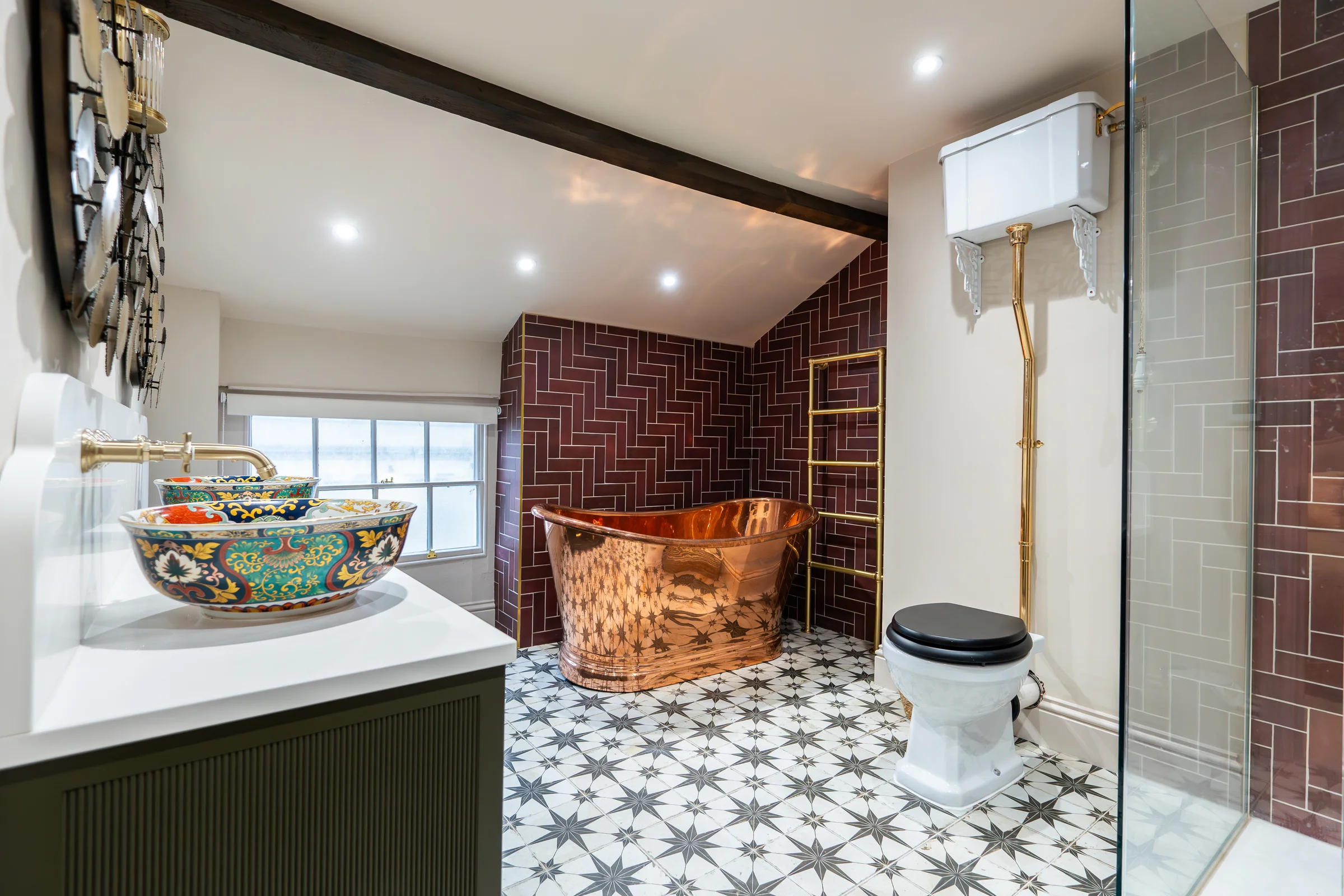 Luxury bathroom copper bath burgundy herringbone tiles ceramic vessel basin olive vanity star floor